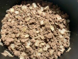 Browning the ground meat with the onion.