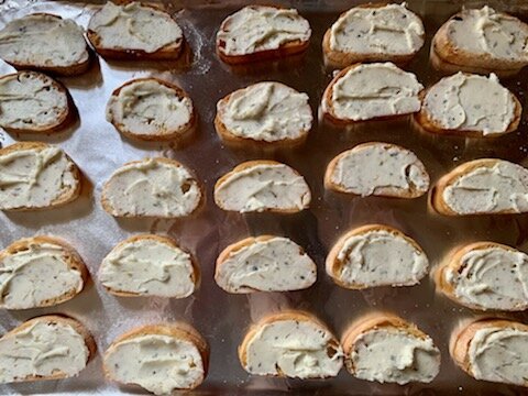 Topping browned baguette with goat cheese mixture