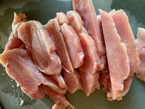 Sliced turkey breast before putting into grinder.