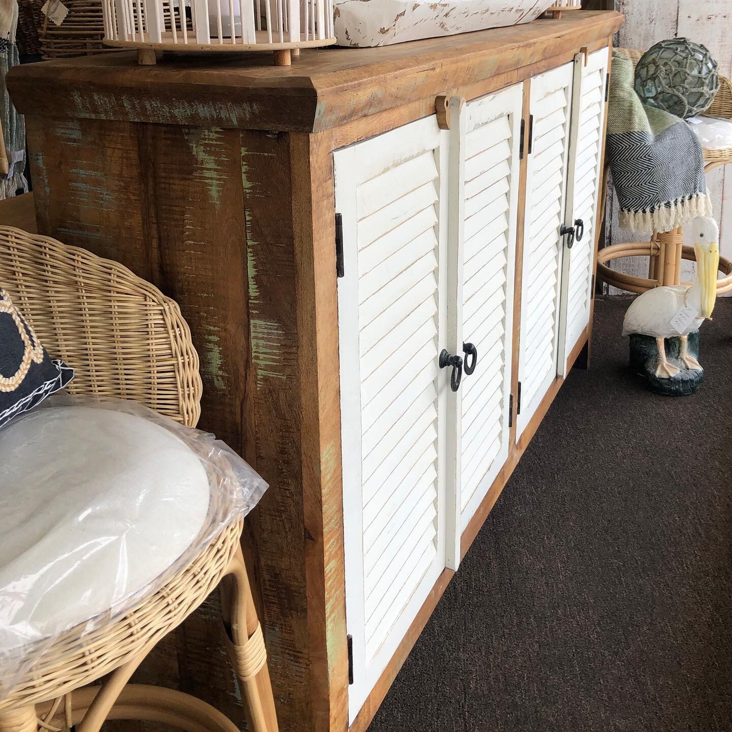 Distressed white shutters combine with natural aged wood to create this relaxed yet sophisticated coastal cabinet/sideboard. This sideboard is substantial with tons of storage. Perfect as a buffet or even as a console, its narrow depth creates versat