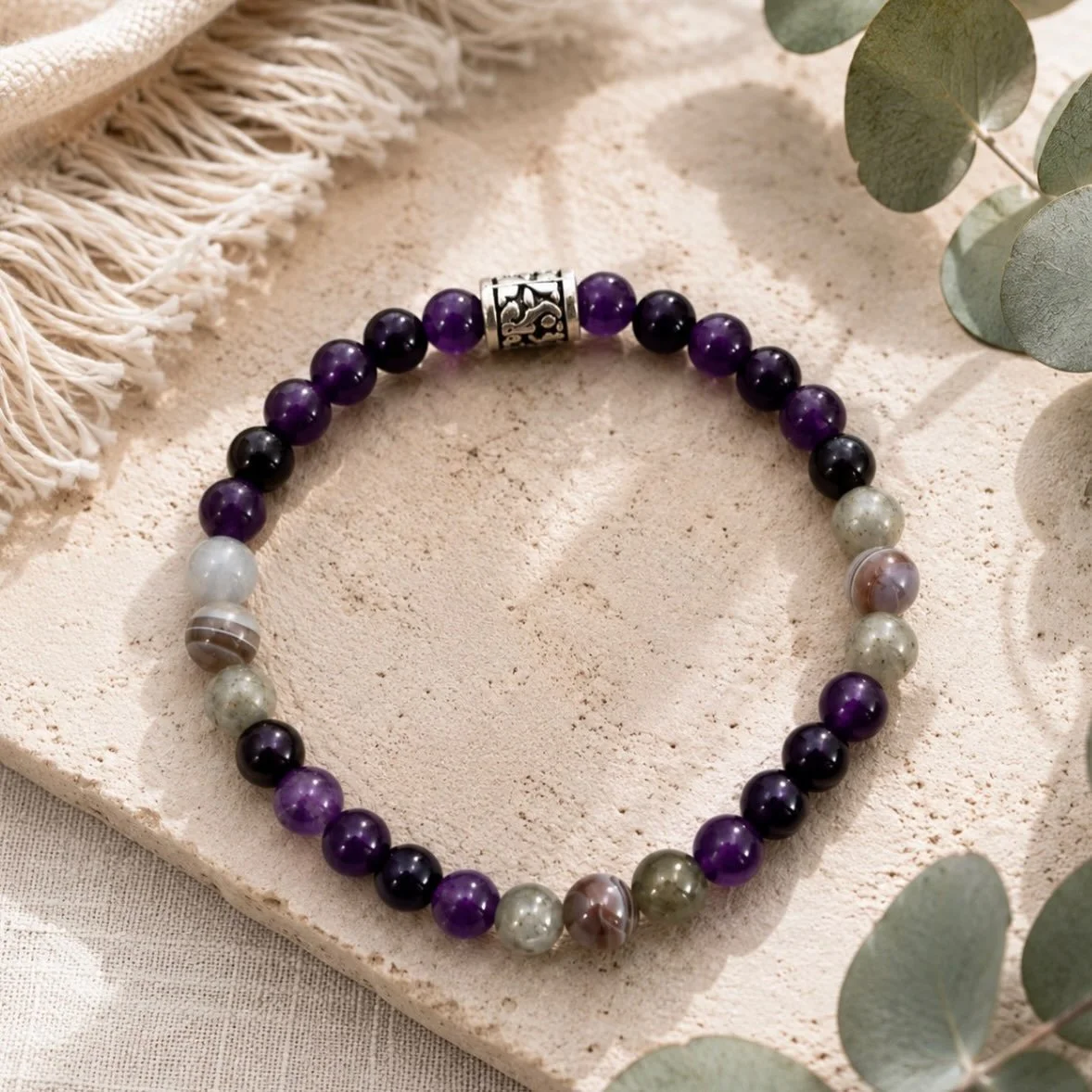 Amethyst does not ask permission before it catches your eye.

That is the first thing you notice about this piece. The deep violet pulls immediately, and then the labradorite shifts in the light and you realize the bracelet is doing something more co