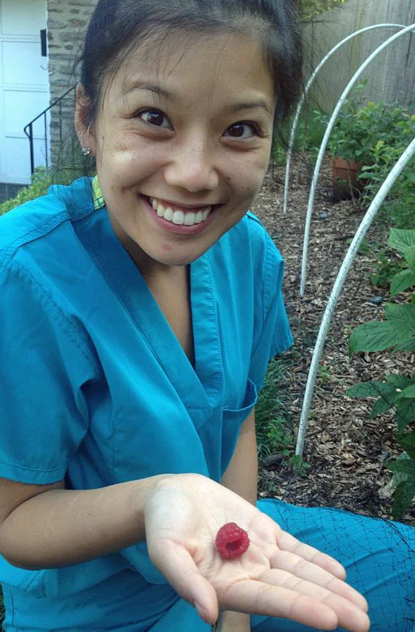 Chris's wife allison celebrates their first raspberry harvest