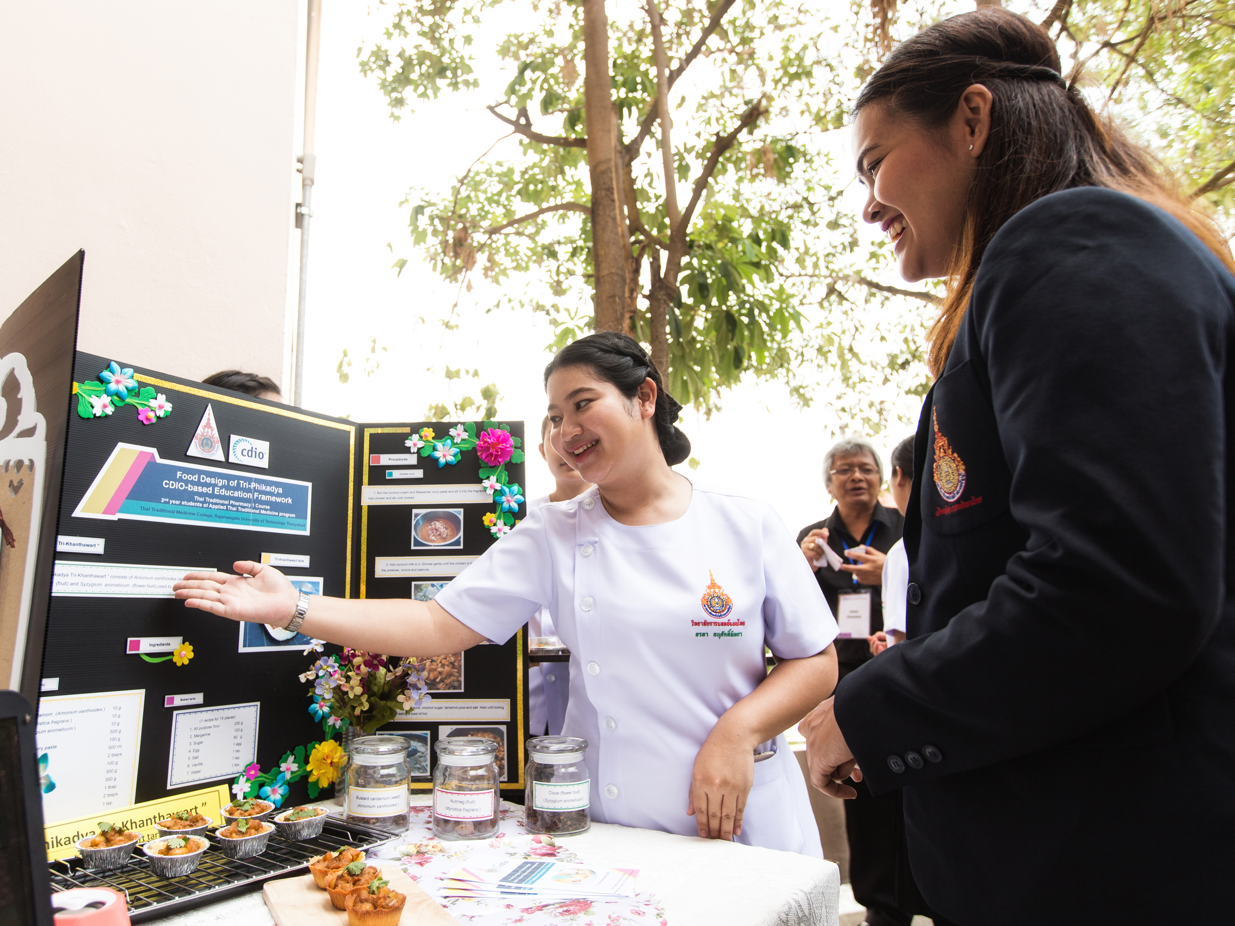  Thai Traditional Medicine College student Orada Anusakpitaya (left), 20, presents her project, where she used traditional herbs to make tarts. Orada not only conceived the idea of healthier pastries, she also convinced her classmates of it through p