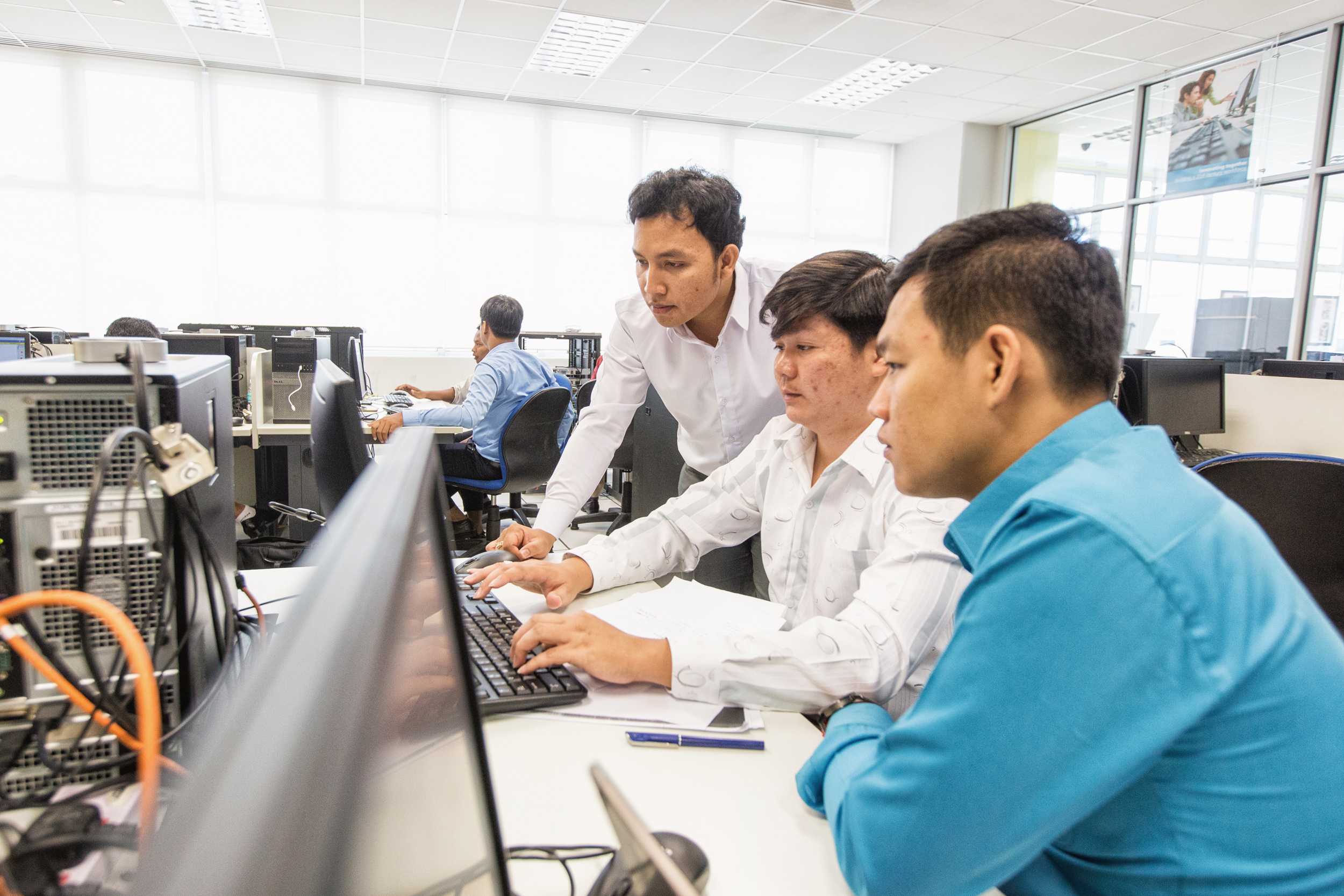  Kimleng Ly (centre), 27, and his team configuring an intra-network. Through TVET, he hopes to bring the latest skills and knowledge to Cambodia for his students at the Regional Polytechnic Institute Techo Sen Battambang. 