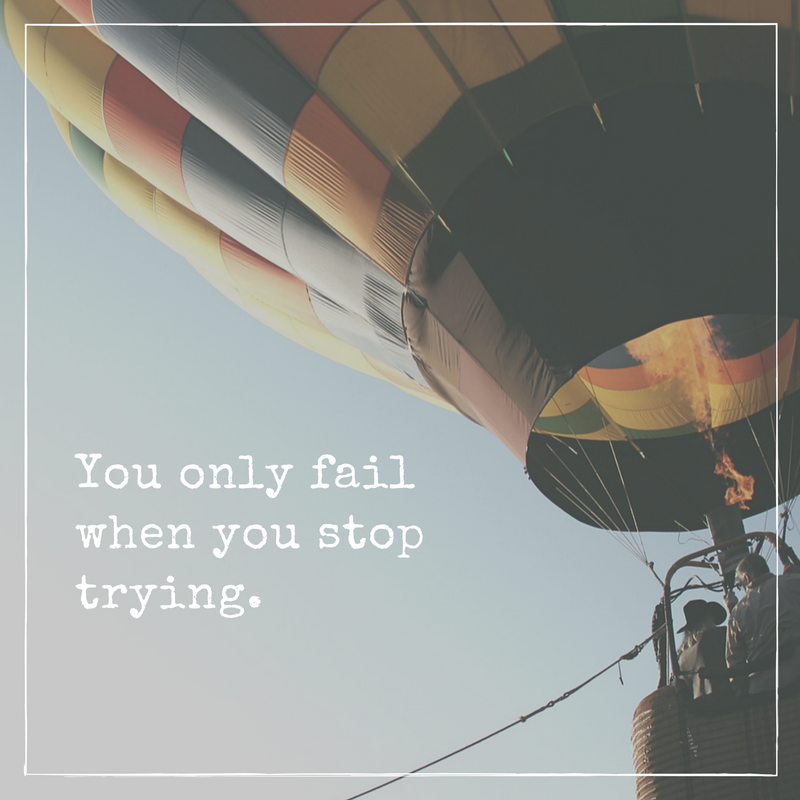 A motivational quote with a colorful hot air balloon floating in the sky. The quote says 'You only fail when you stop trying.'