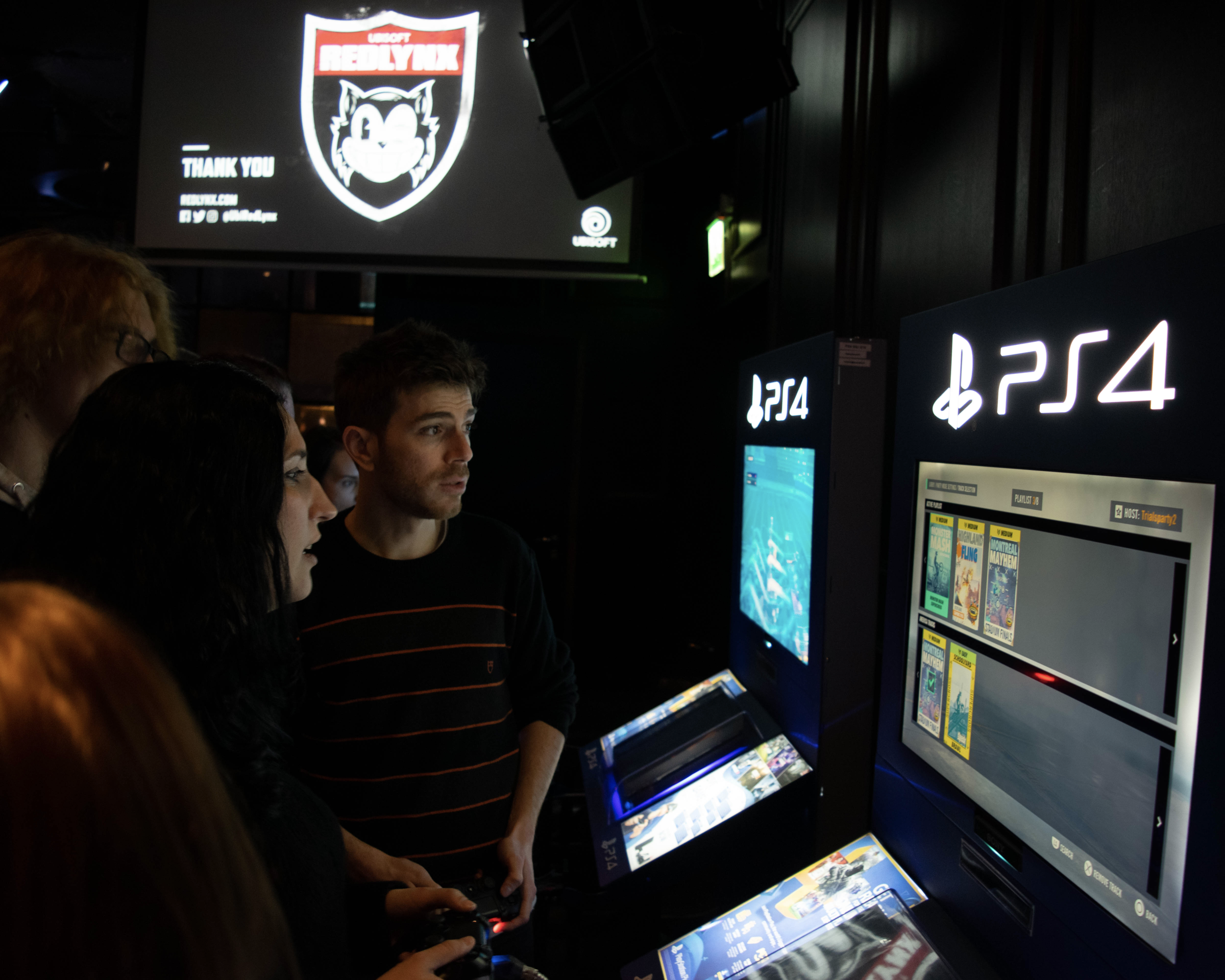 Gathering visitors playing Trials Rising. Photo by Casimir Kuusela.