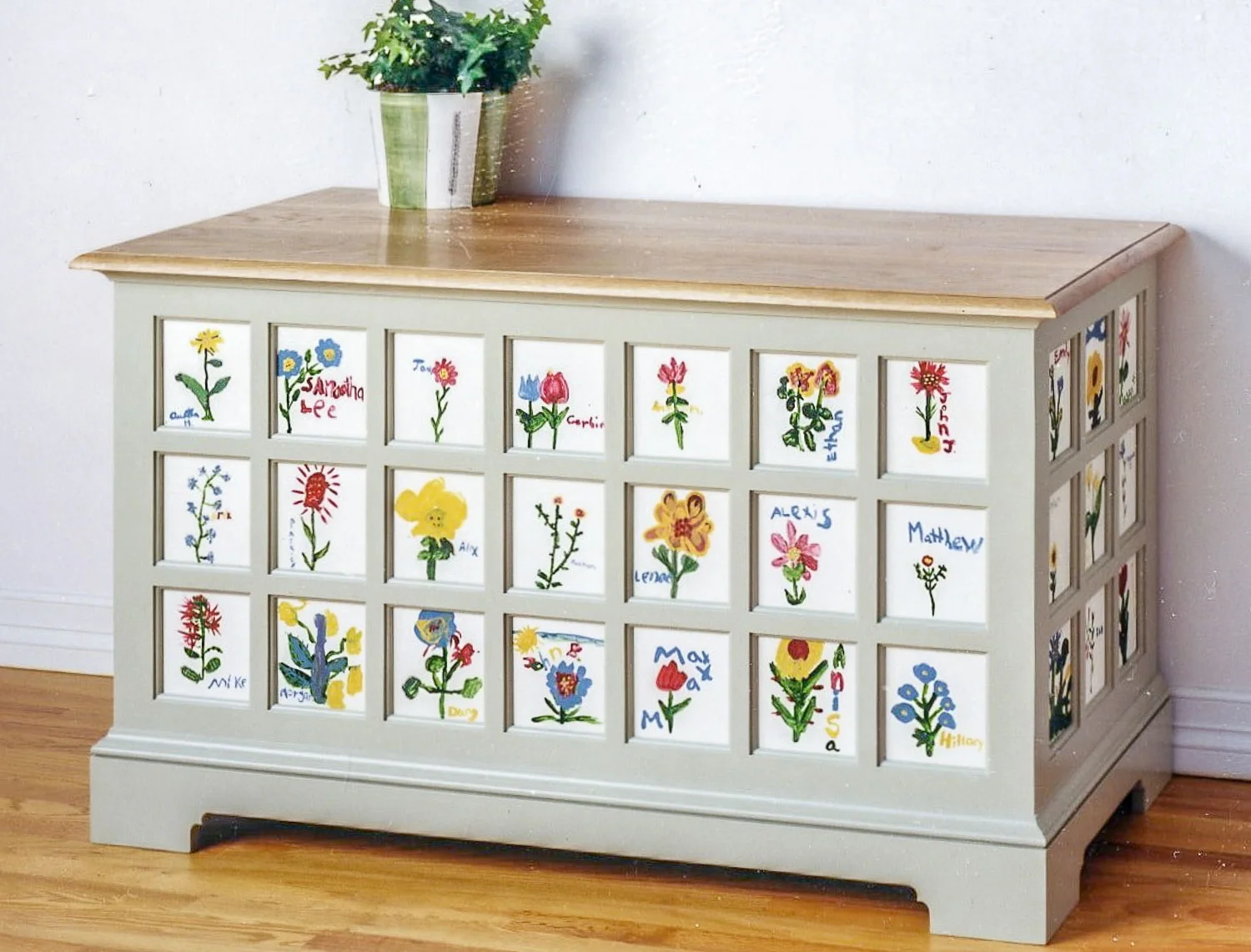 Blanket chest with panels painted by elementary school students; white oak top