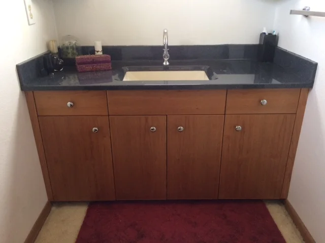  Cherry vanity with cultured stone counter. 