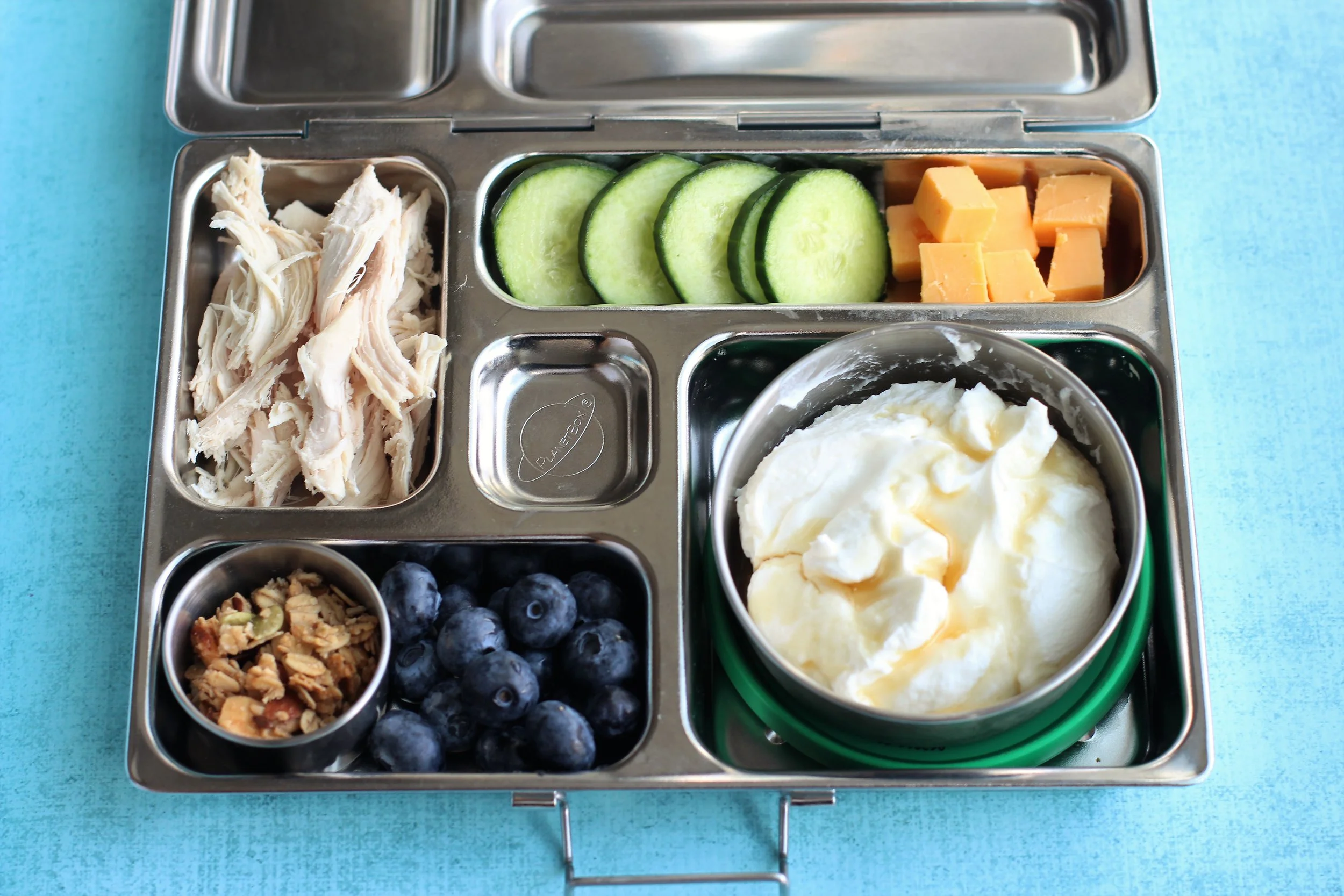 Shredded rotisserie chicken, sliced cukes, cheese cubes, Greek yogurt with maple syrup, granola and blueberries
