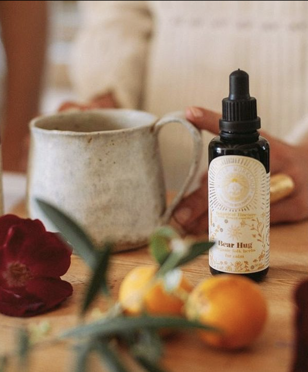 wunder workshop bear hug tincture bottle with a mug