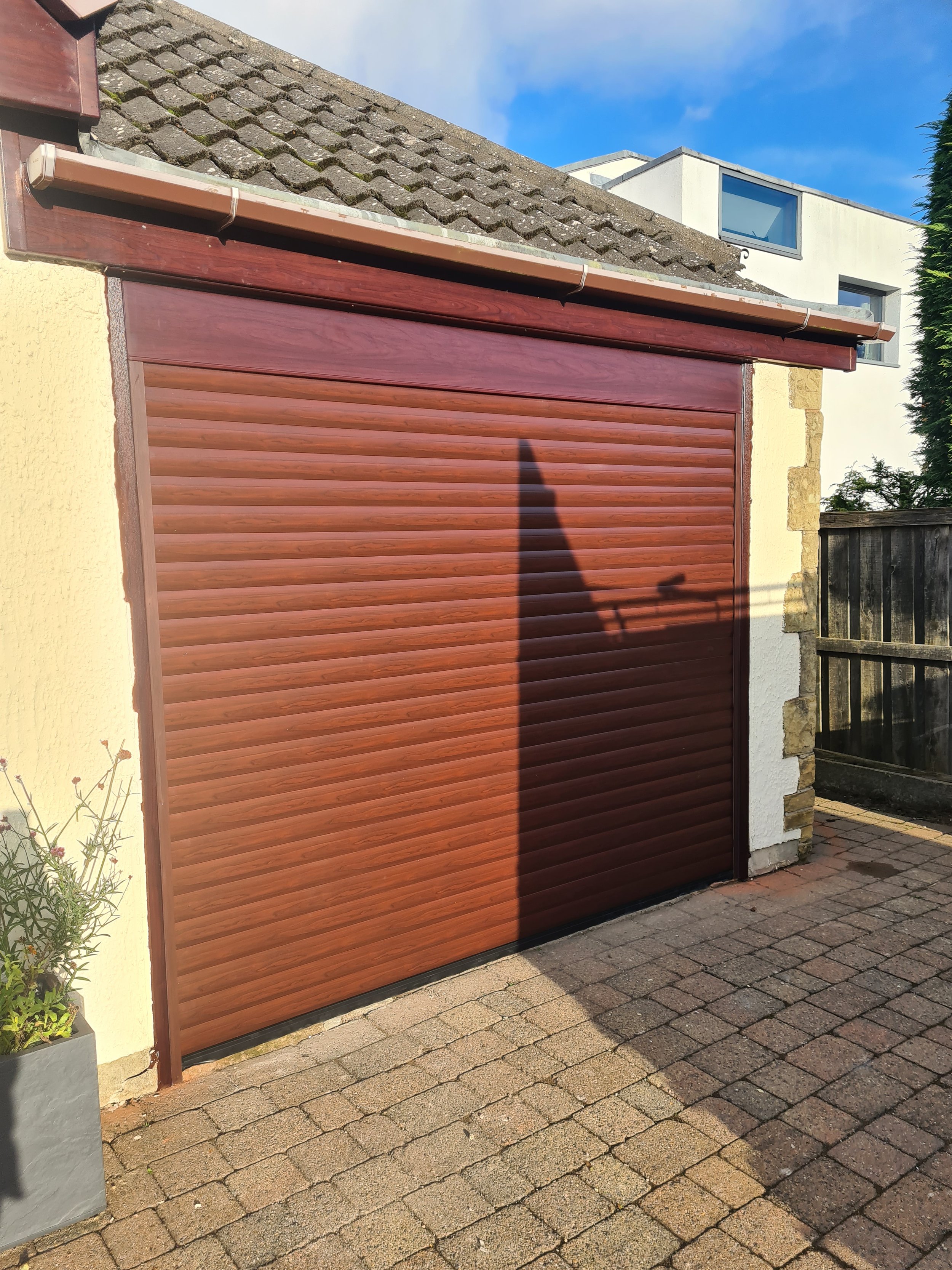 Uk Doors Midlands Classic 77m fully insulated roller garage door in Textured Rosewood W/ matching frame