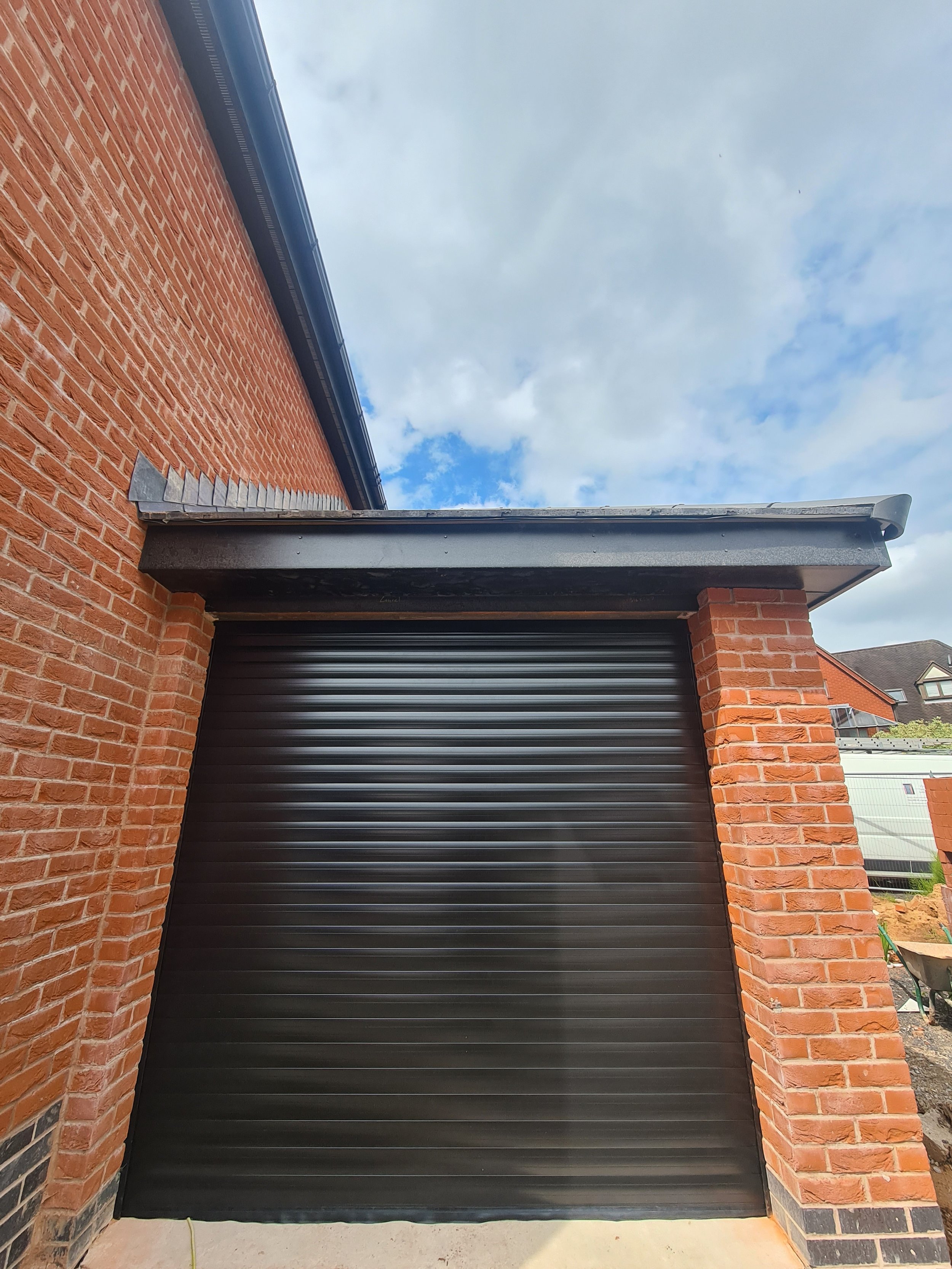 Uk Doors Midlands Classic 77m fully insulated roller garage door in smooth Black W/ matching frame