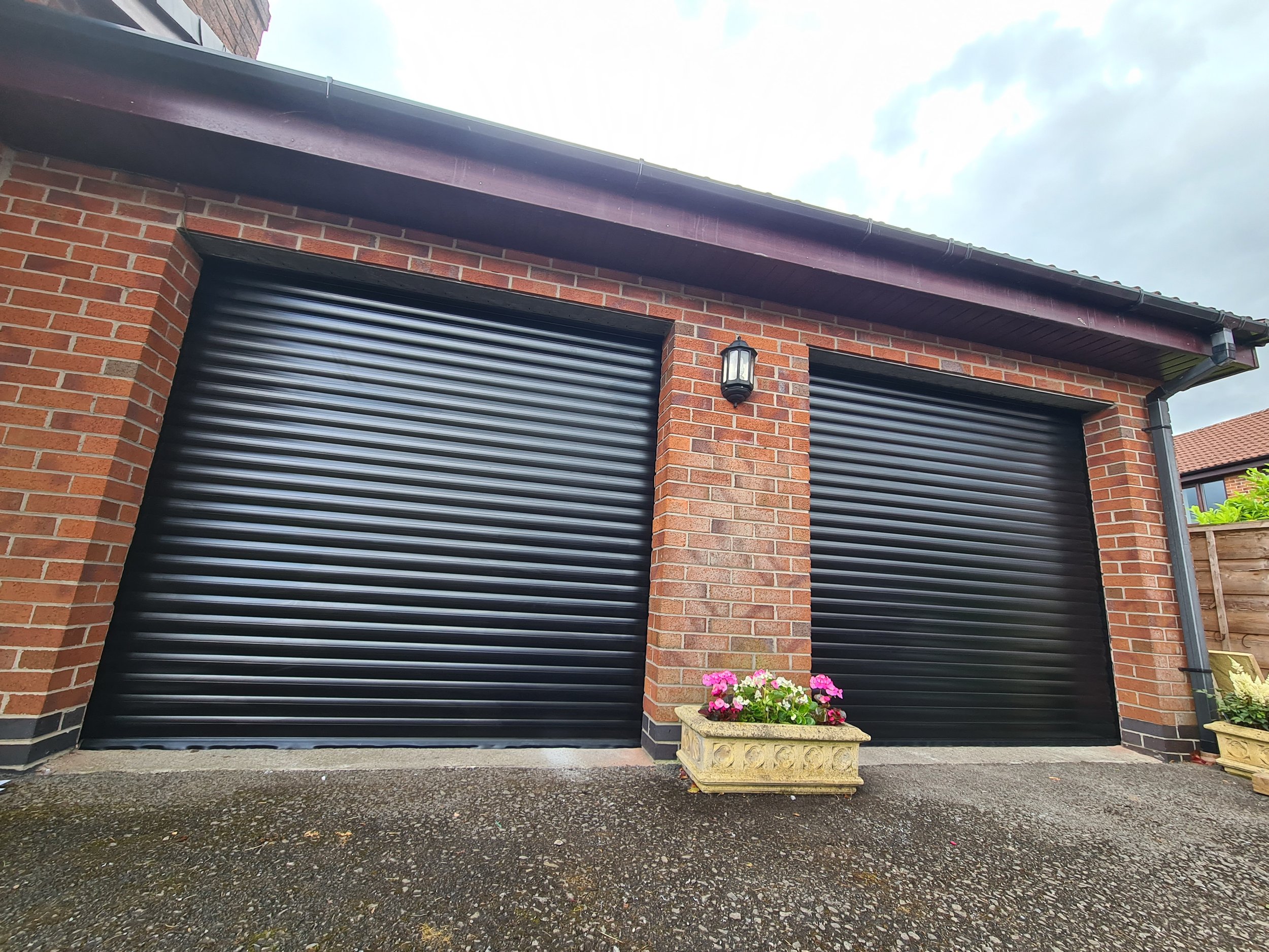 Uk Doors Midlands Classic 77m fully insulated roller garage door in smooth Black W/ matching frame