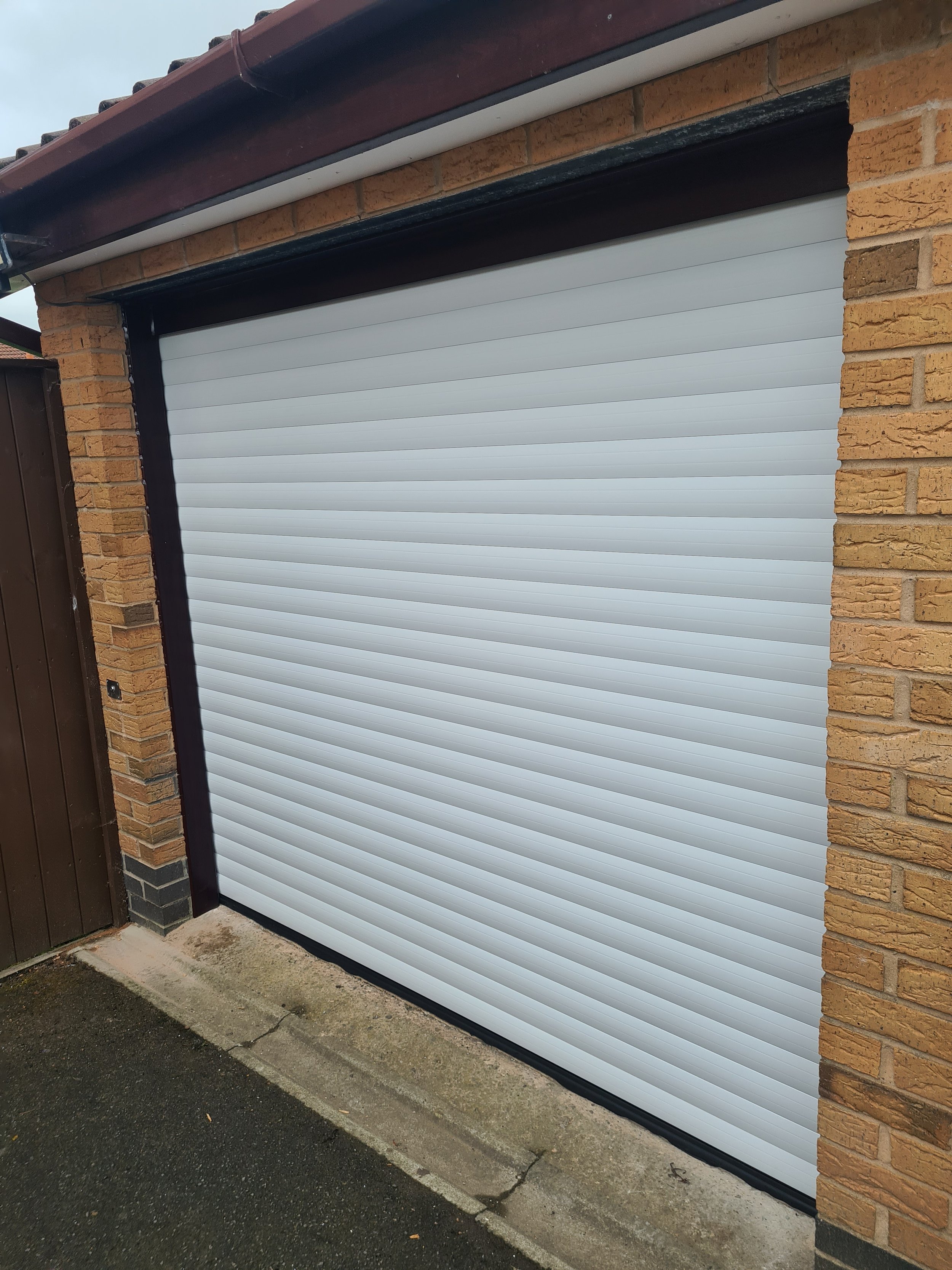Uk Doors Midlands Classic 77m fully insulated roller garage door in smooth Ivory W/ Rosewood frame
