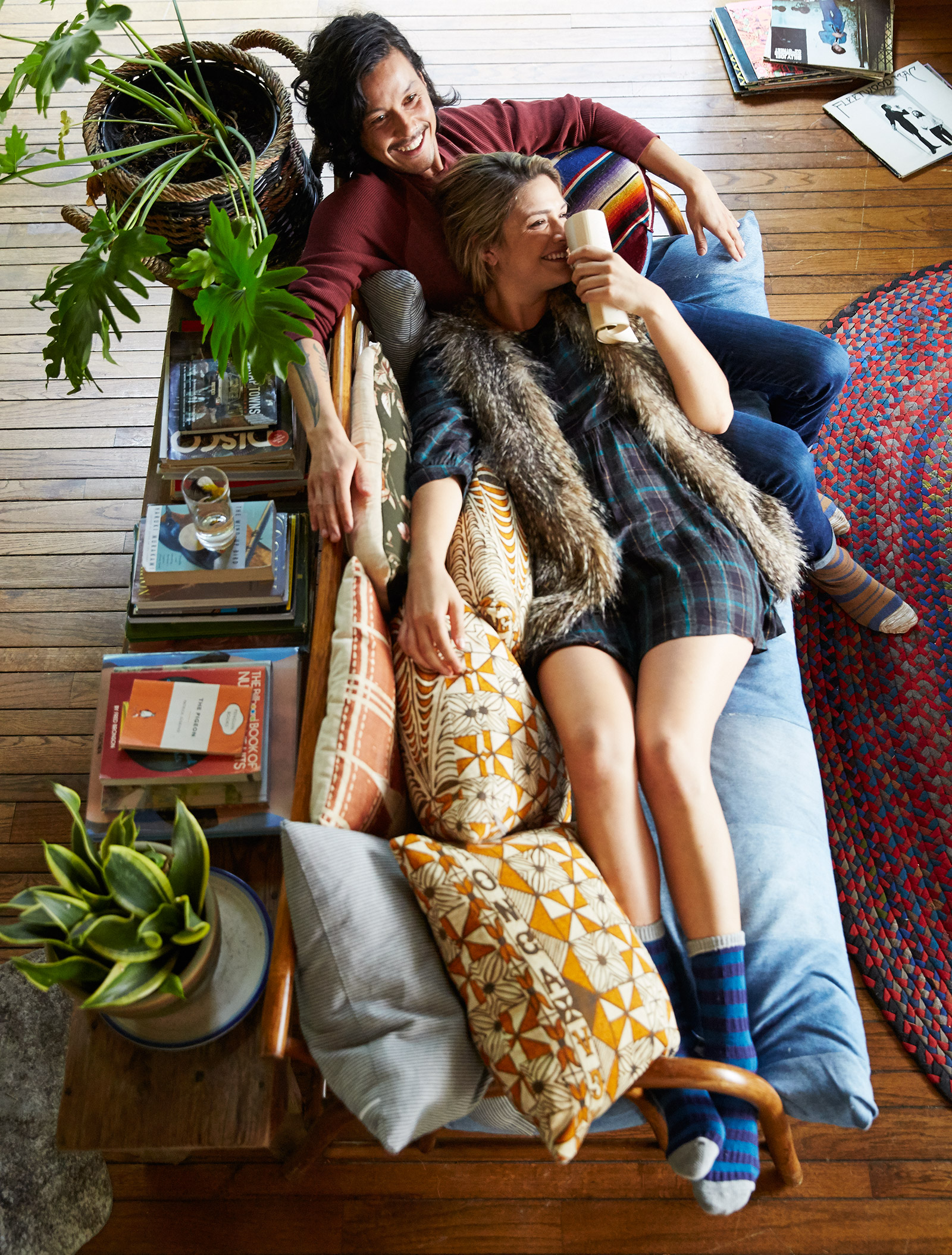 couple cuddling on couch while reading