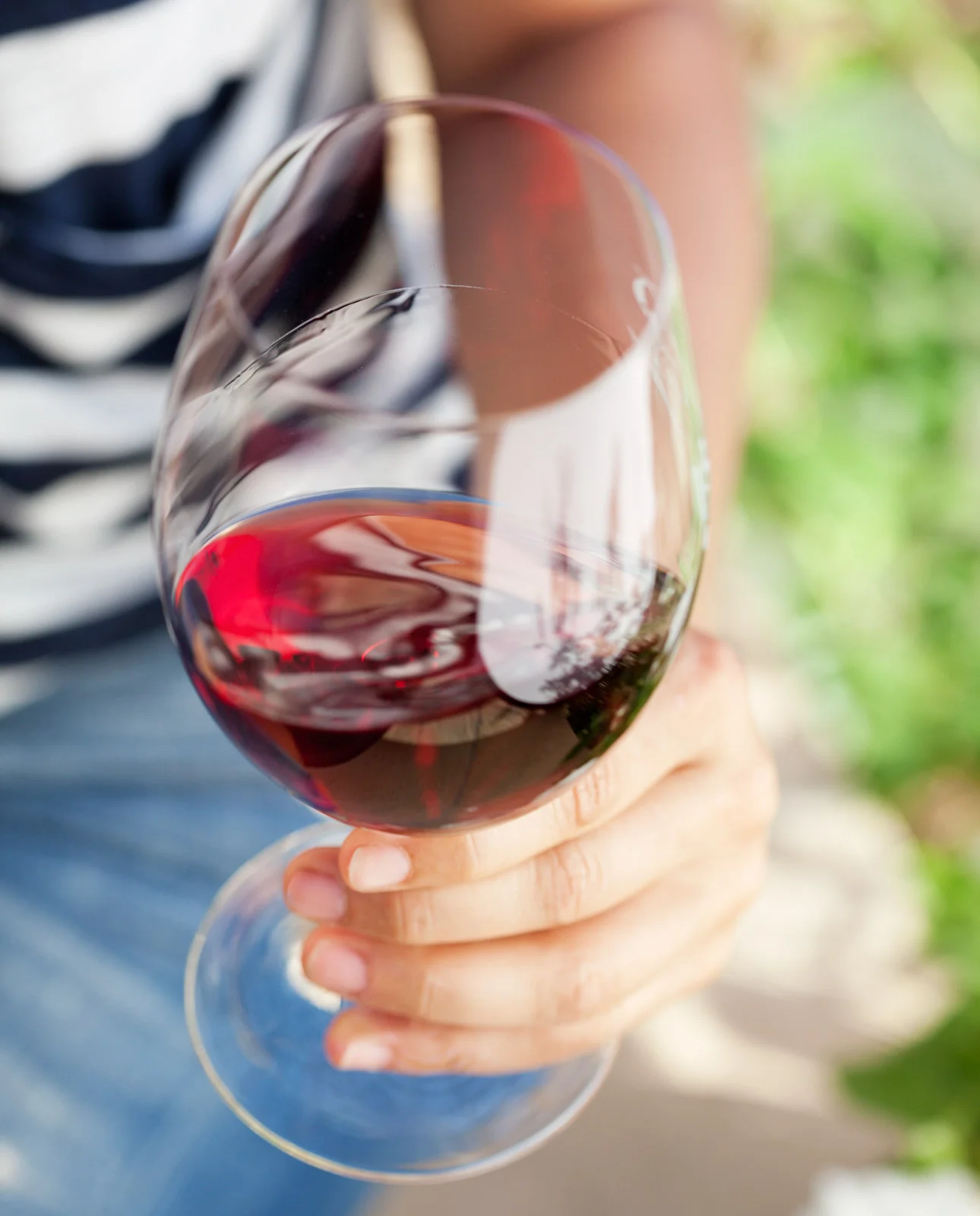 woman holding glass of red wine in Napa Valley