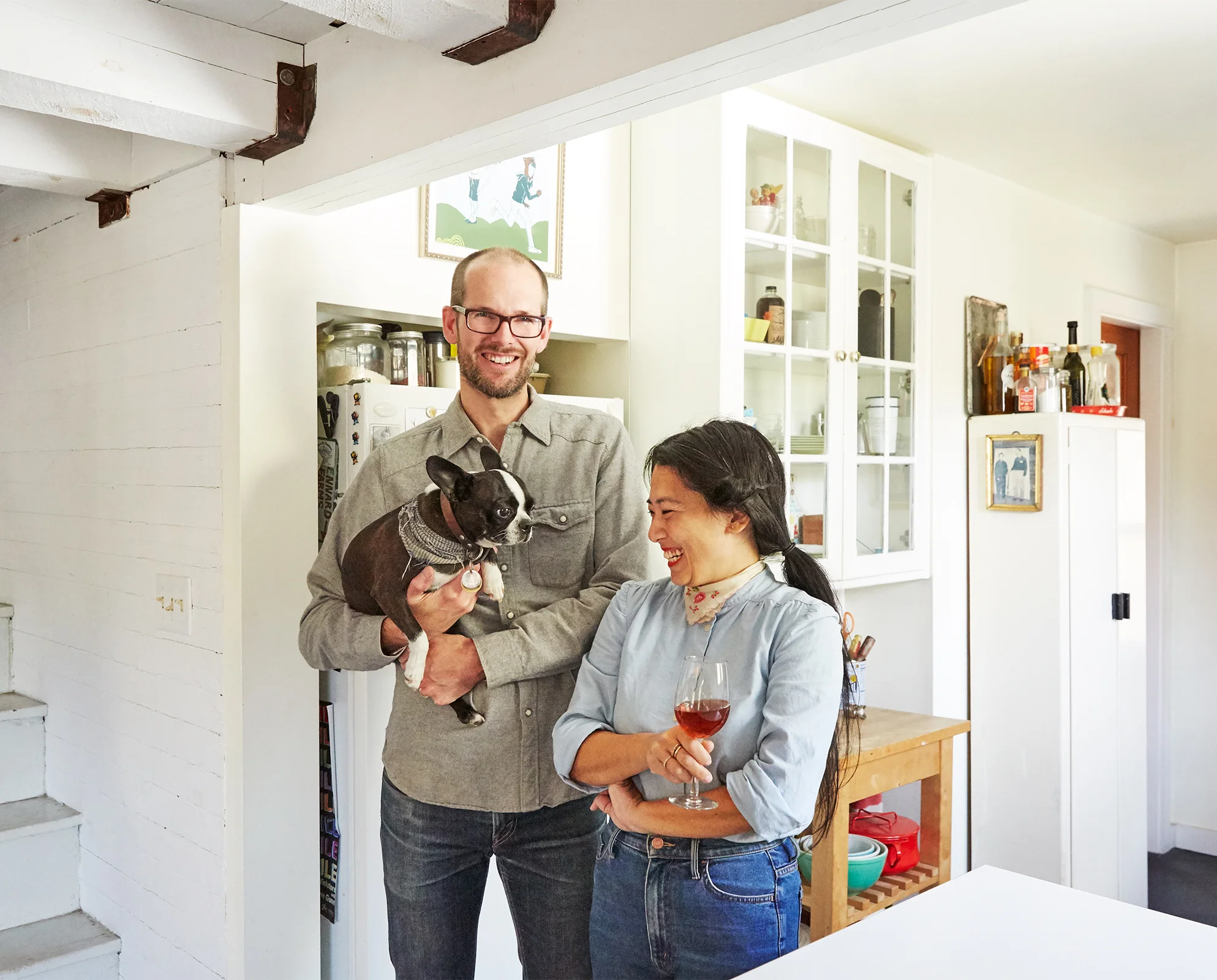 Couple in kitchen with dog