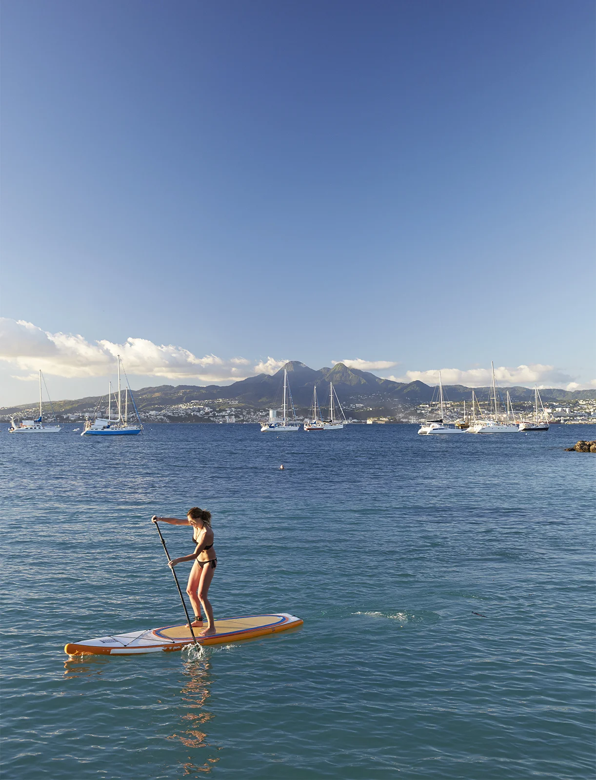 Woman paddleboarding in the ocean