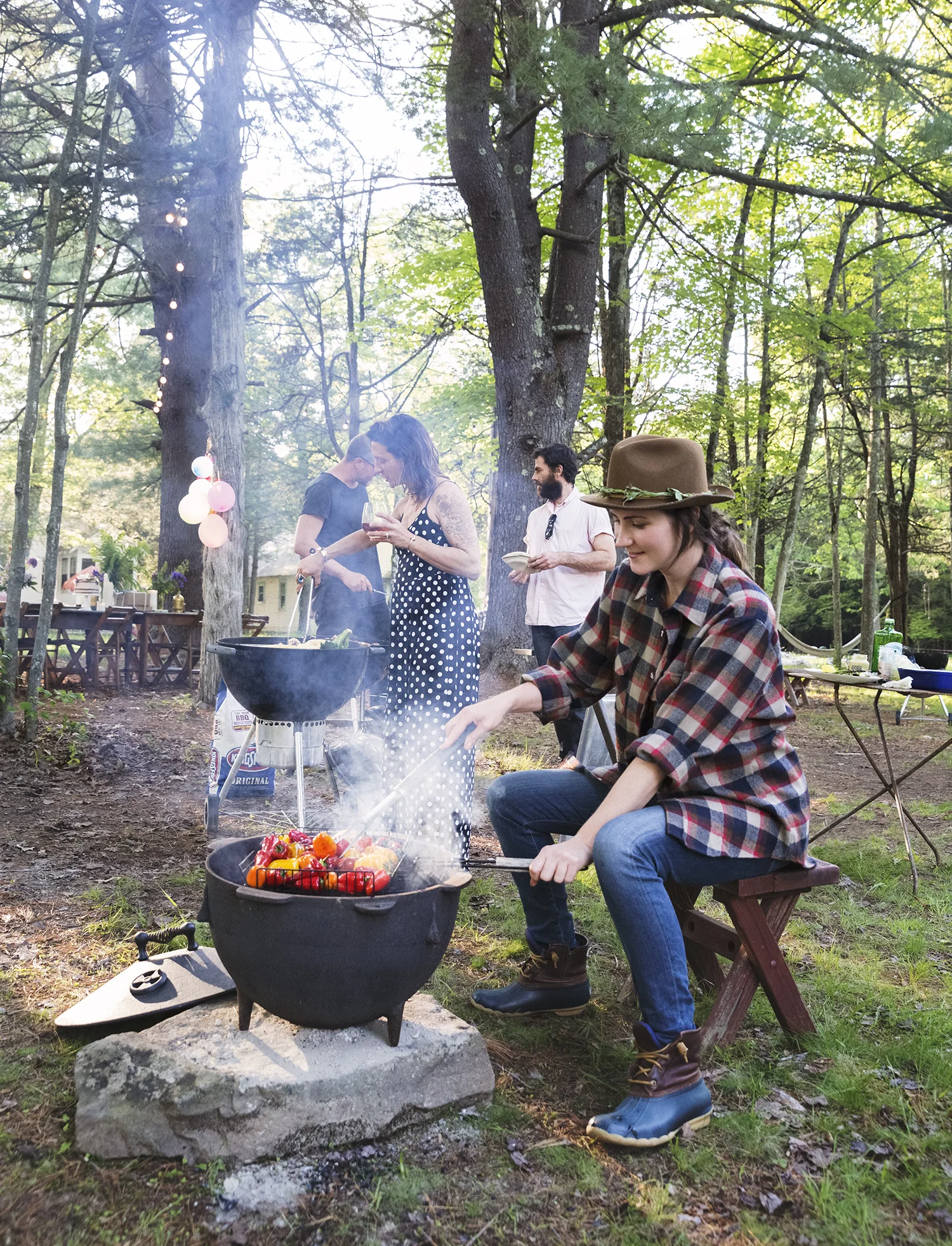 Woman cooking at a grill outdoors