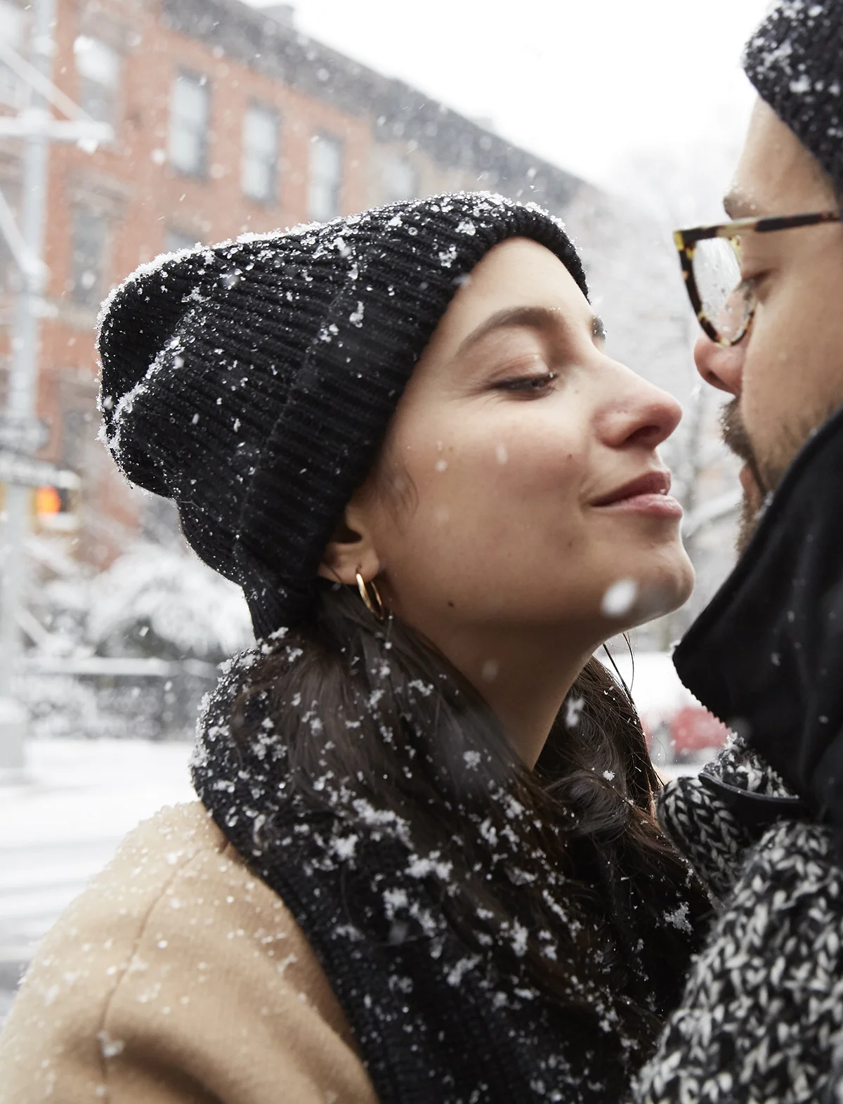Couple about to kiss in snow
