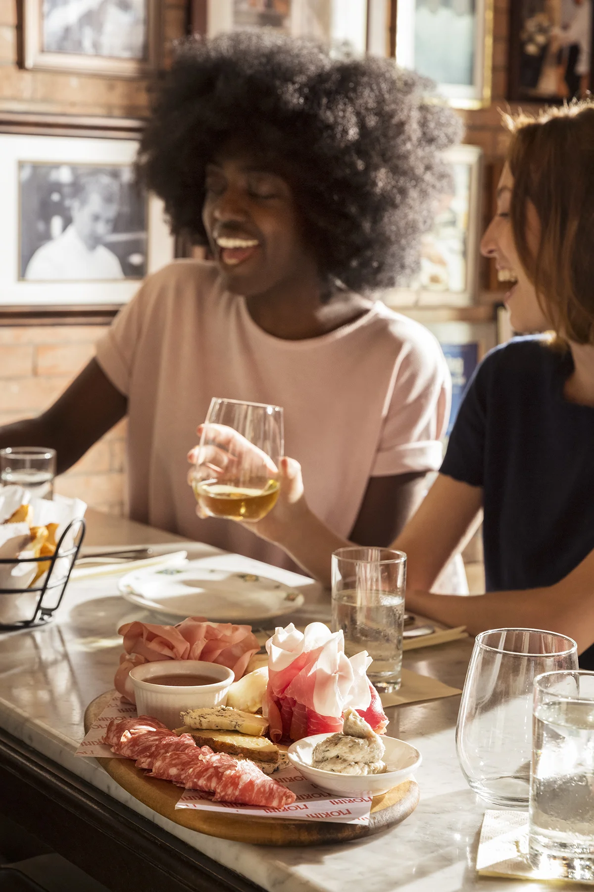 Friends enjoying cheese and wine at a restaurant