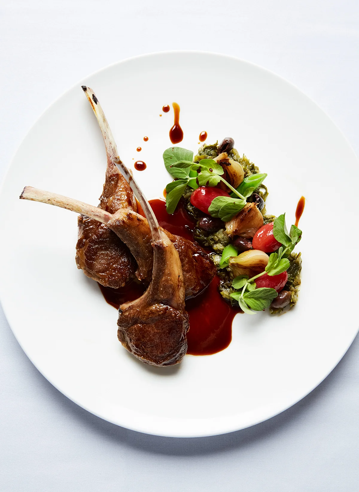 Beautifully plated rack of lamb with green salad