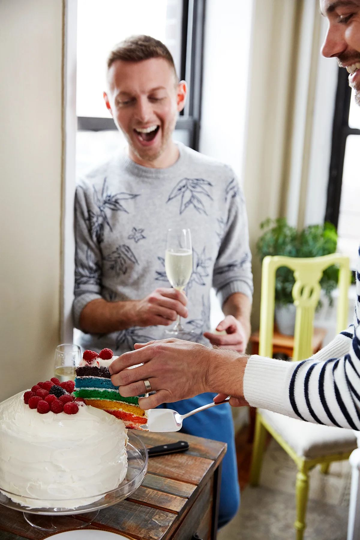Gay couple celebrate marriage with rainbow cake