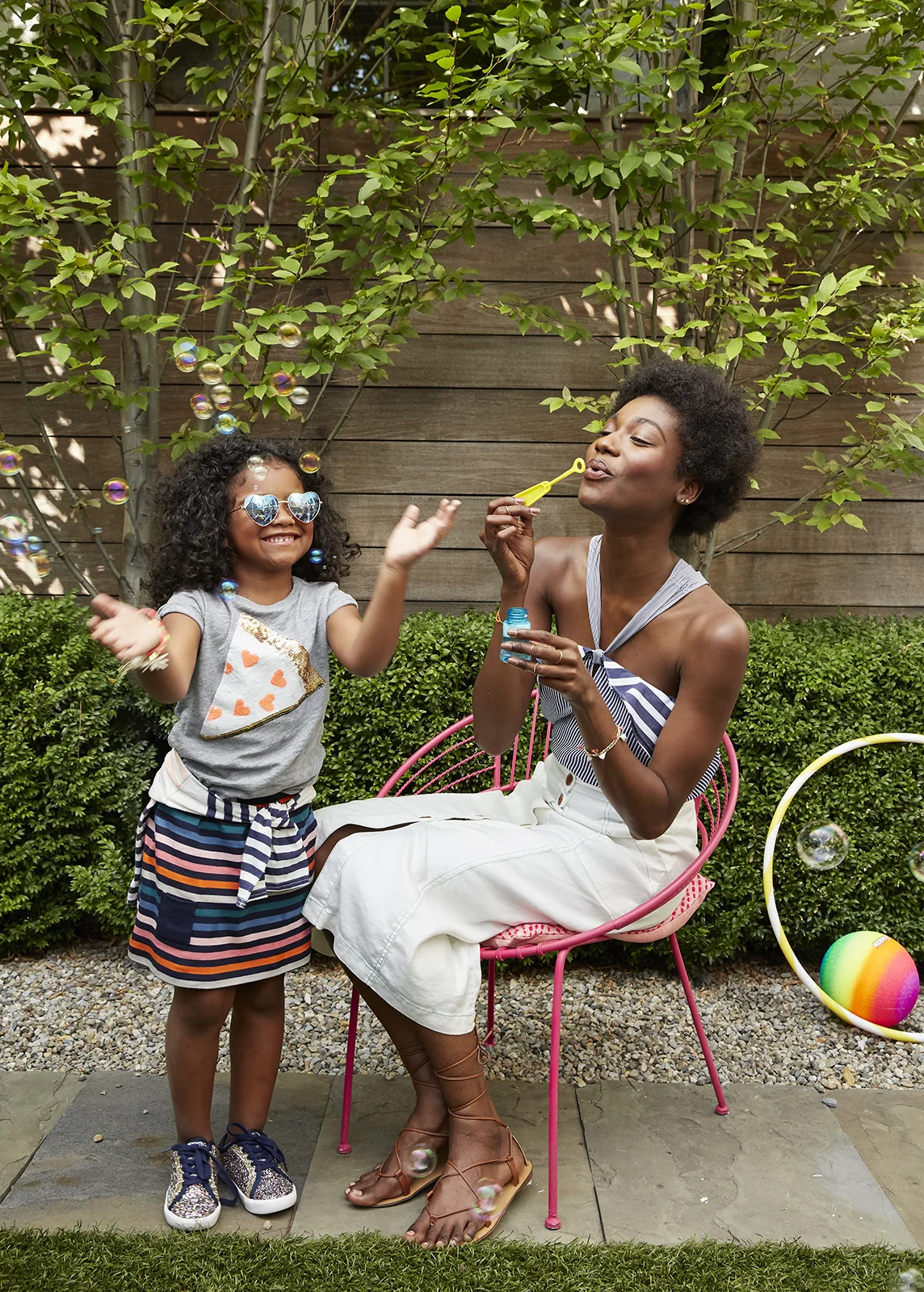 Mother and daughter blowing bubbles