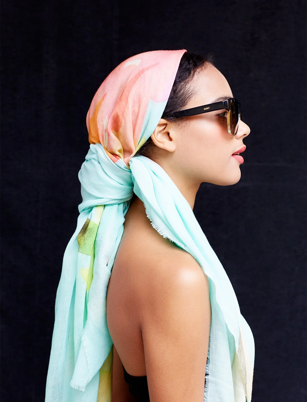 Model wearing silk scarf with sunglasses