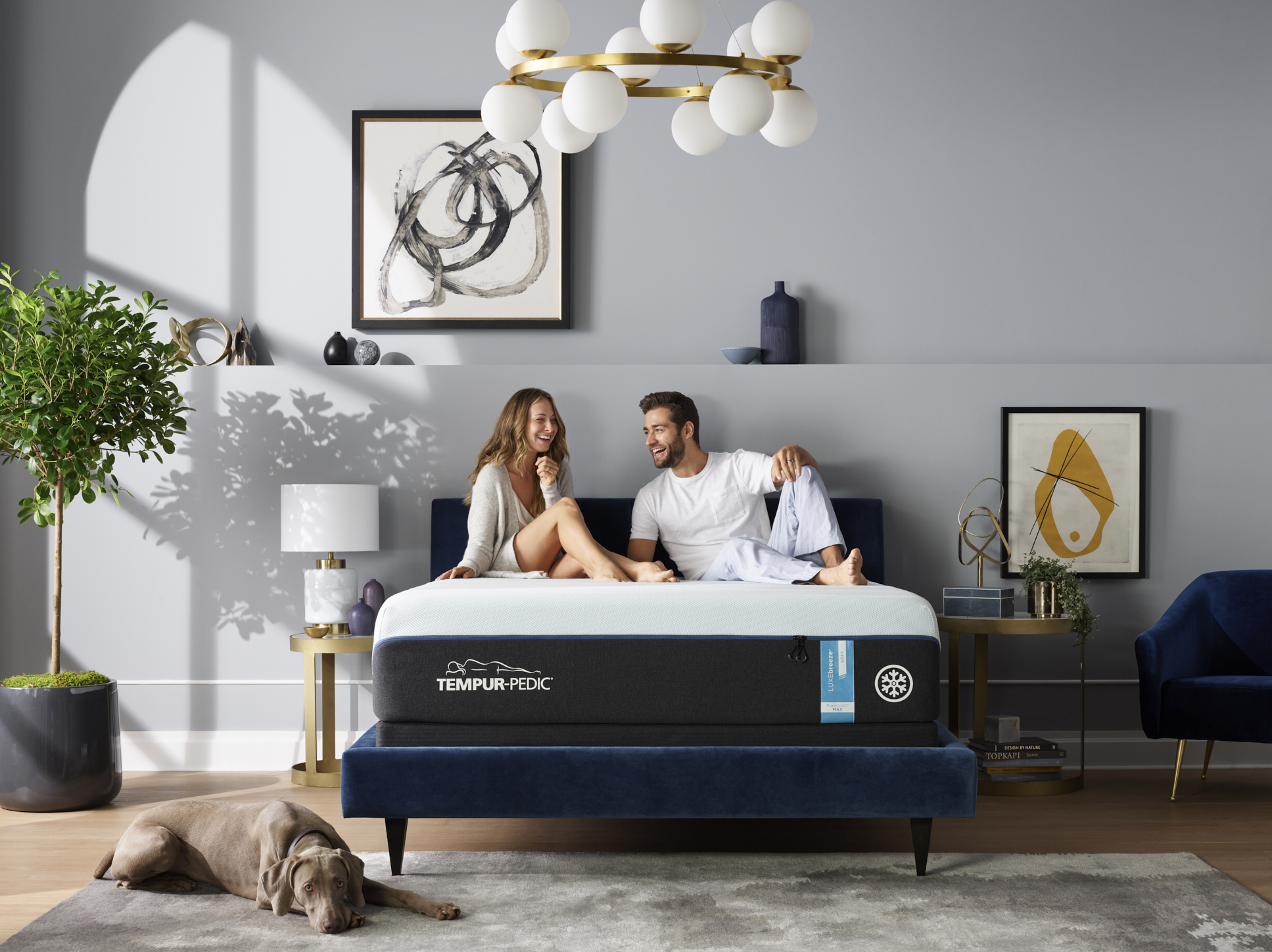 Couple hanging out on bed with dog