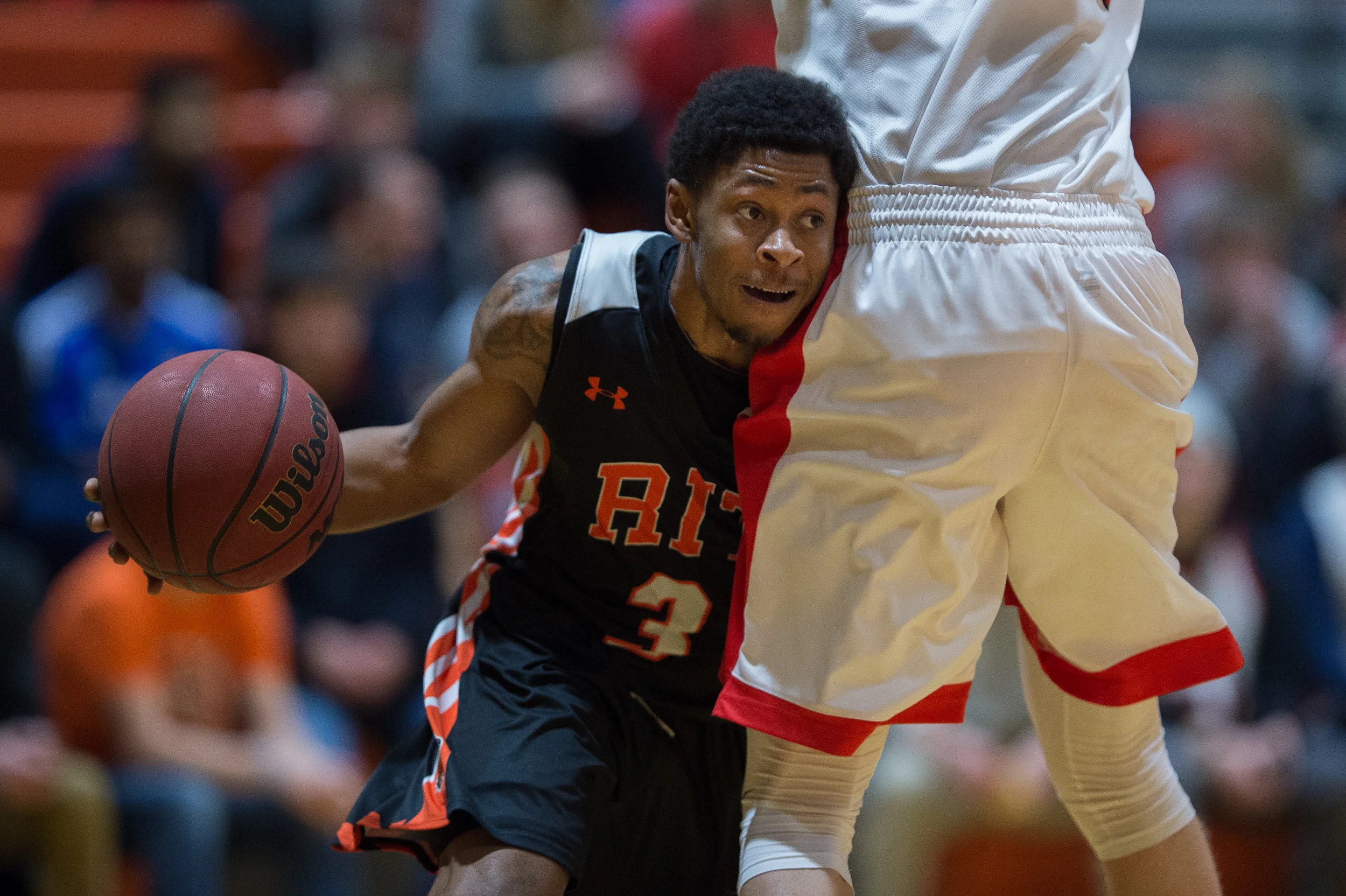 RIT Tigers AJ Horde, 3, collides with RPI Engineers Marcus Giese, 42, while making a dash to the rim during the 1st half in the Clark Gym on the Rochester Institute of Technology campus in Henrietta, N.Y. on Jan. 29, 2016. The Tigers went on to defeat the Engineers 65-57.
