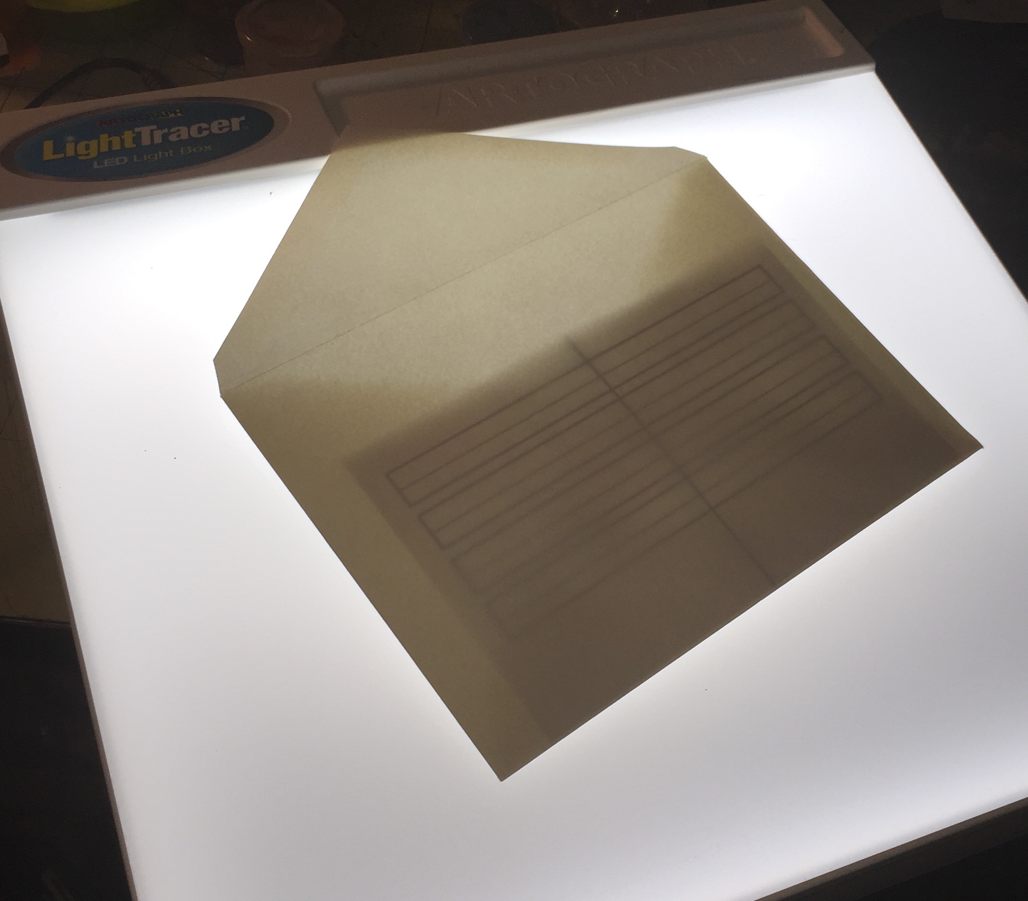 Non-opaque envelopes or papers are pretty much "solved" with a lightbox. I use a Light Tracer... They are starting to make them flat, but I prefer the slanted surface.