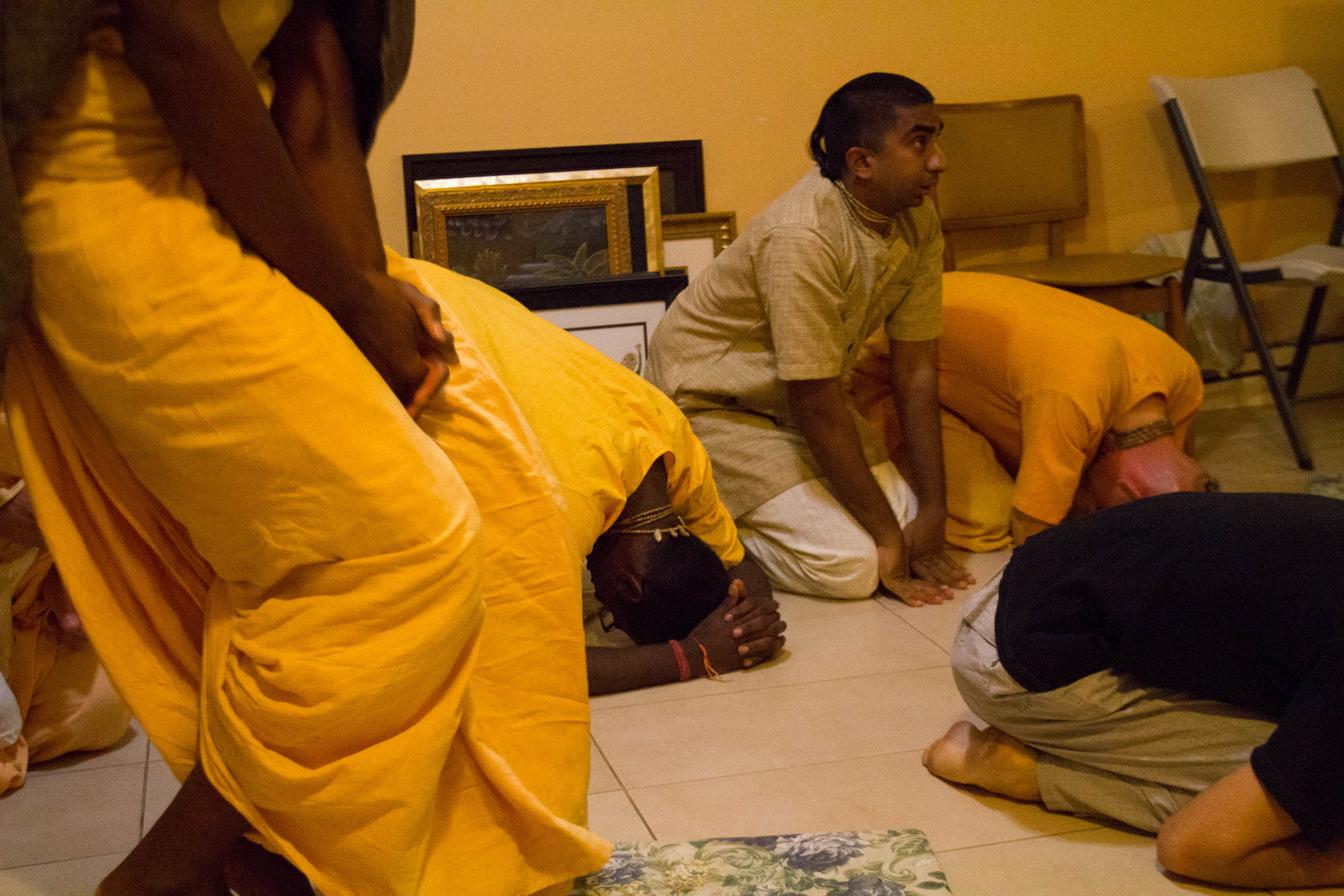  Nihal kneels down to pray during Sunday morning prayers at his communal home in Brooklyn 