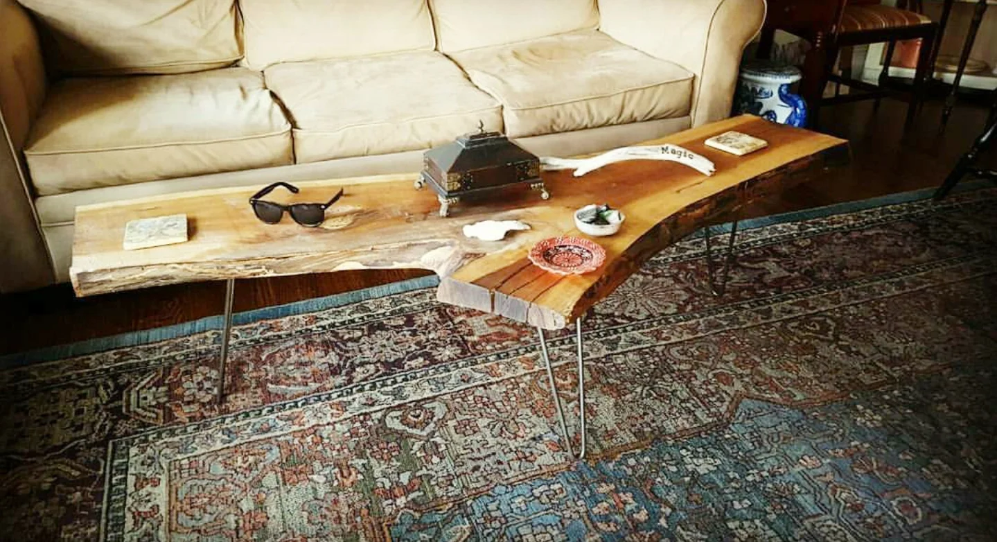 Salvaged live edge wood coffee table with hairpin legs.