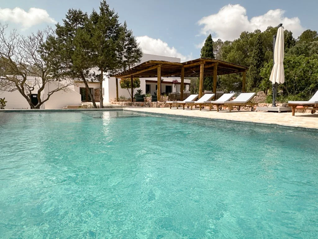 View of an Ibicencan white finca with the pool at the front.