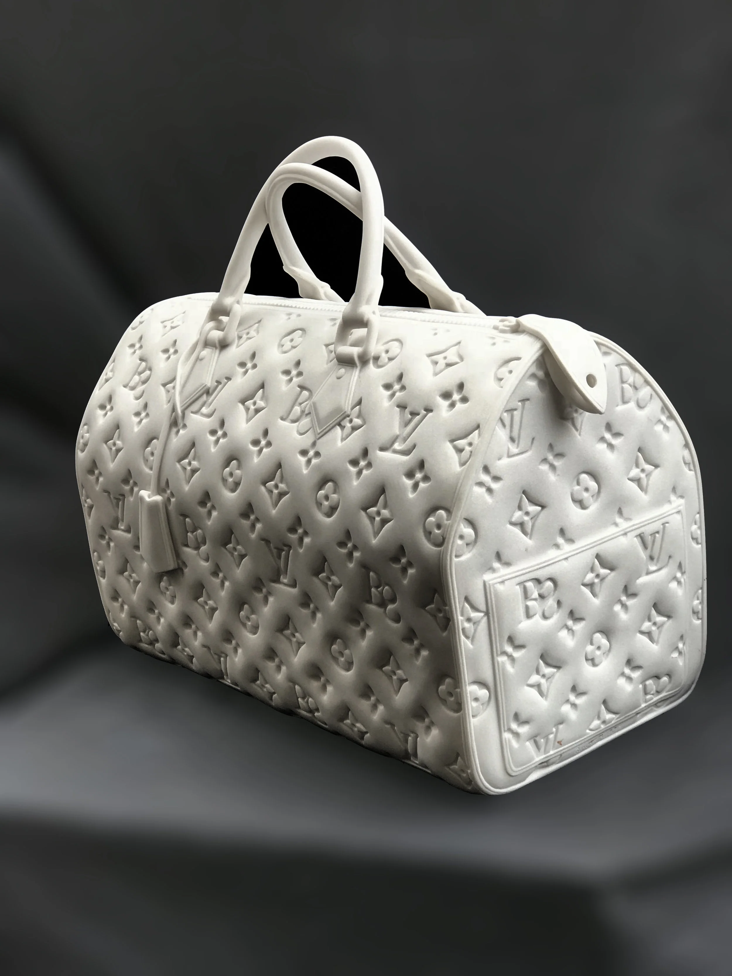 Designer Handbags In the Cathedral Candy Series, my sculptures reinforce the bags iconic status - presenting an object that is by nature ephemeral, and then transforming it into an enduring, almost religious, idol for worship. In the Designer Handbags series, I explore society's long-standing obsession with status symbols and my own ambivalent relationship with them. The stone purses underscore the inherent contradiction of man's, and woman's, never-ending quest for ephemeral prizes.