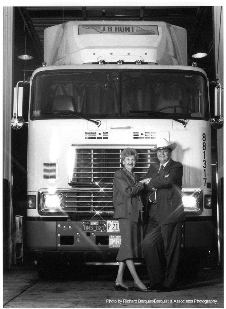 Johnelle and J.B. Hunt stand in front of one of their trucks in 1988.