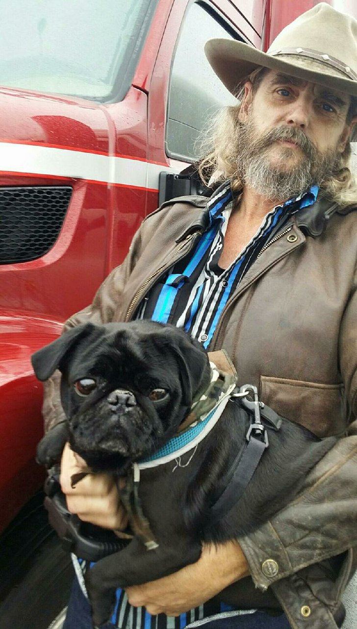 Truck driver Jim Farmer holds Bruiser. Farmer is part of Operation Roger, a nonprofit that matches truck drivers with rescued pets for transport across the country.