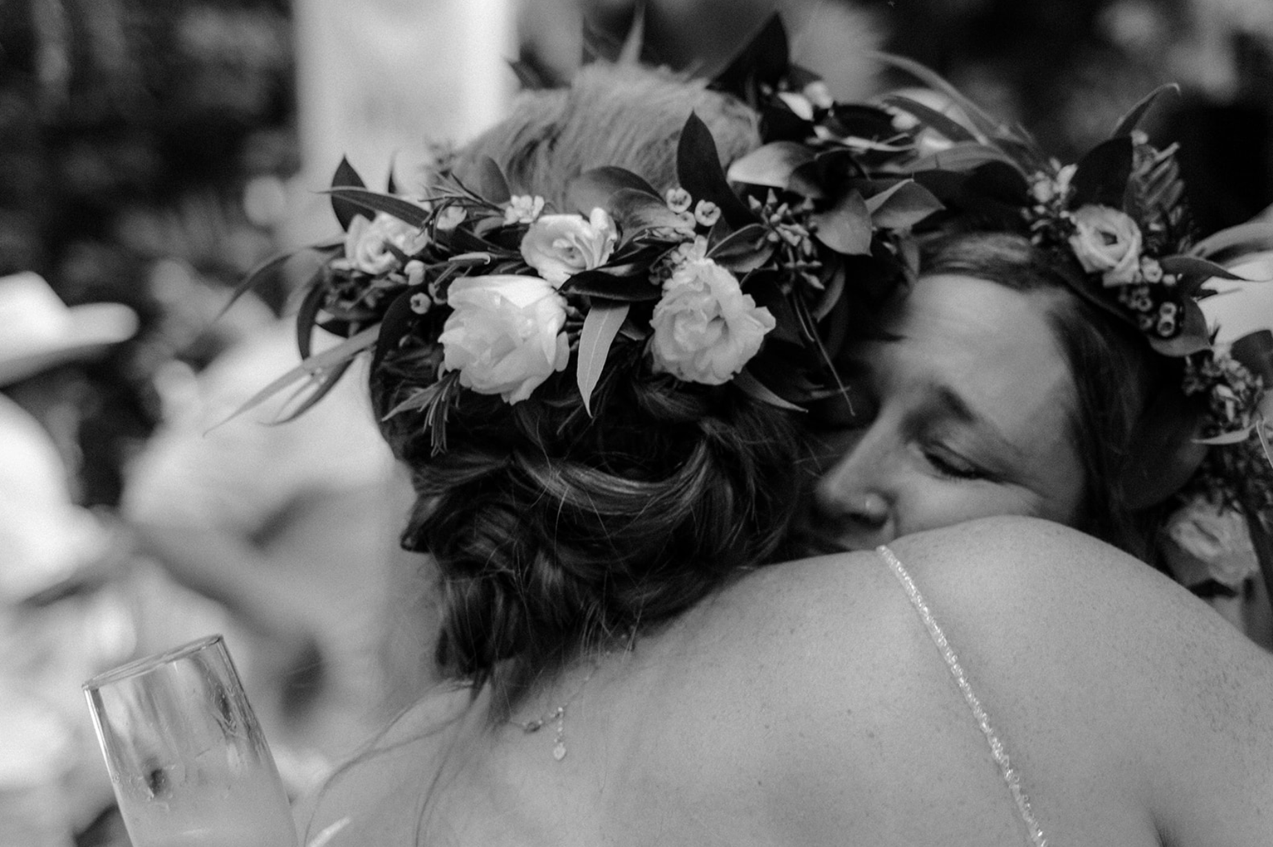 Emotional black and white wedding photo of bride and maid of honor