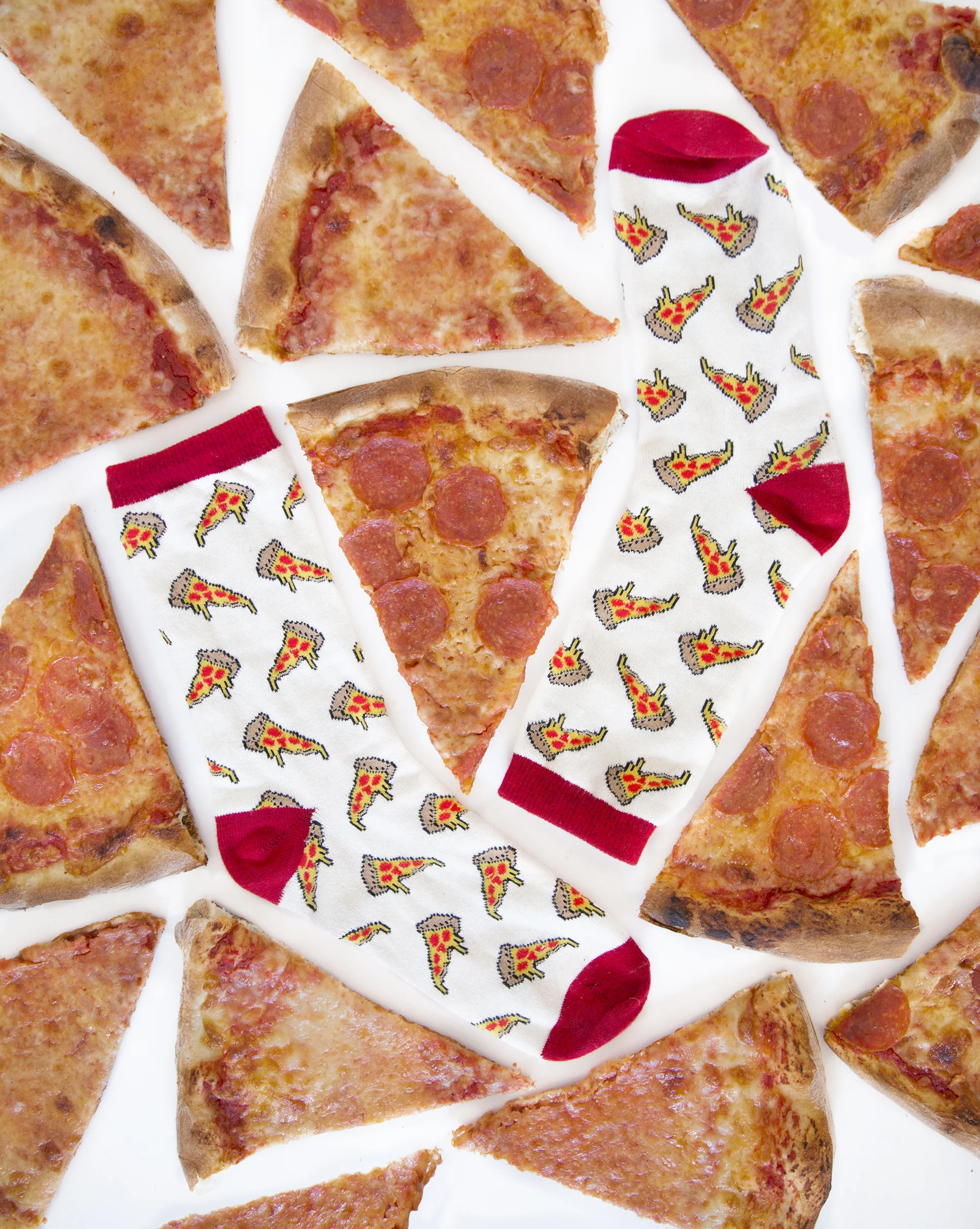 Pizza themed socks ($8), purchased from Urban Outfitters, lie beside pizzas from T Anthony’s Pizzeria, Oct. 10.