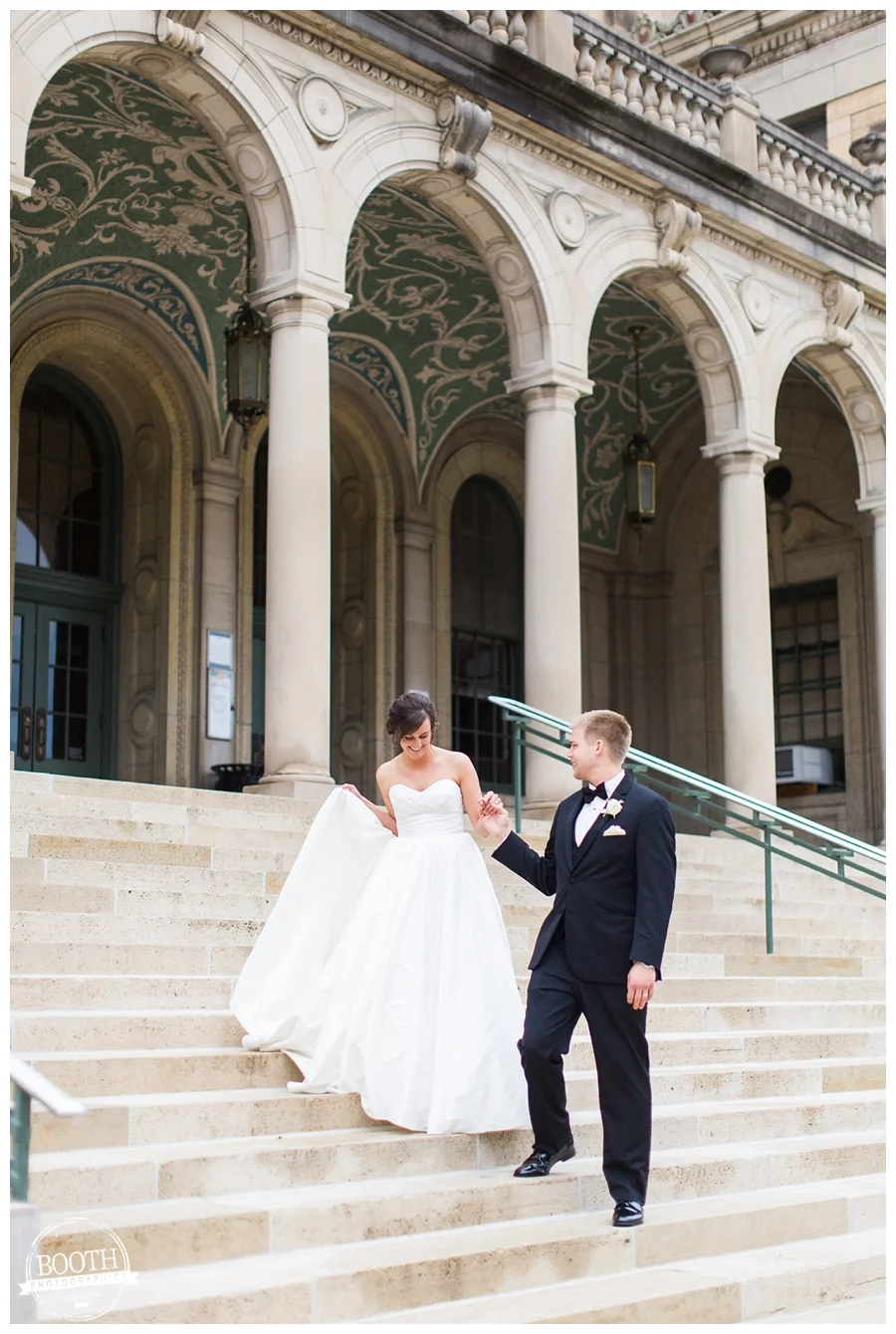 bride and groom on the front steps of the UW memorial union at their elegant wedding