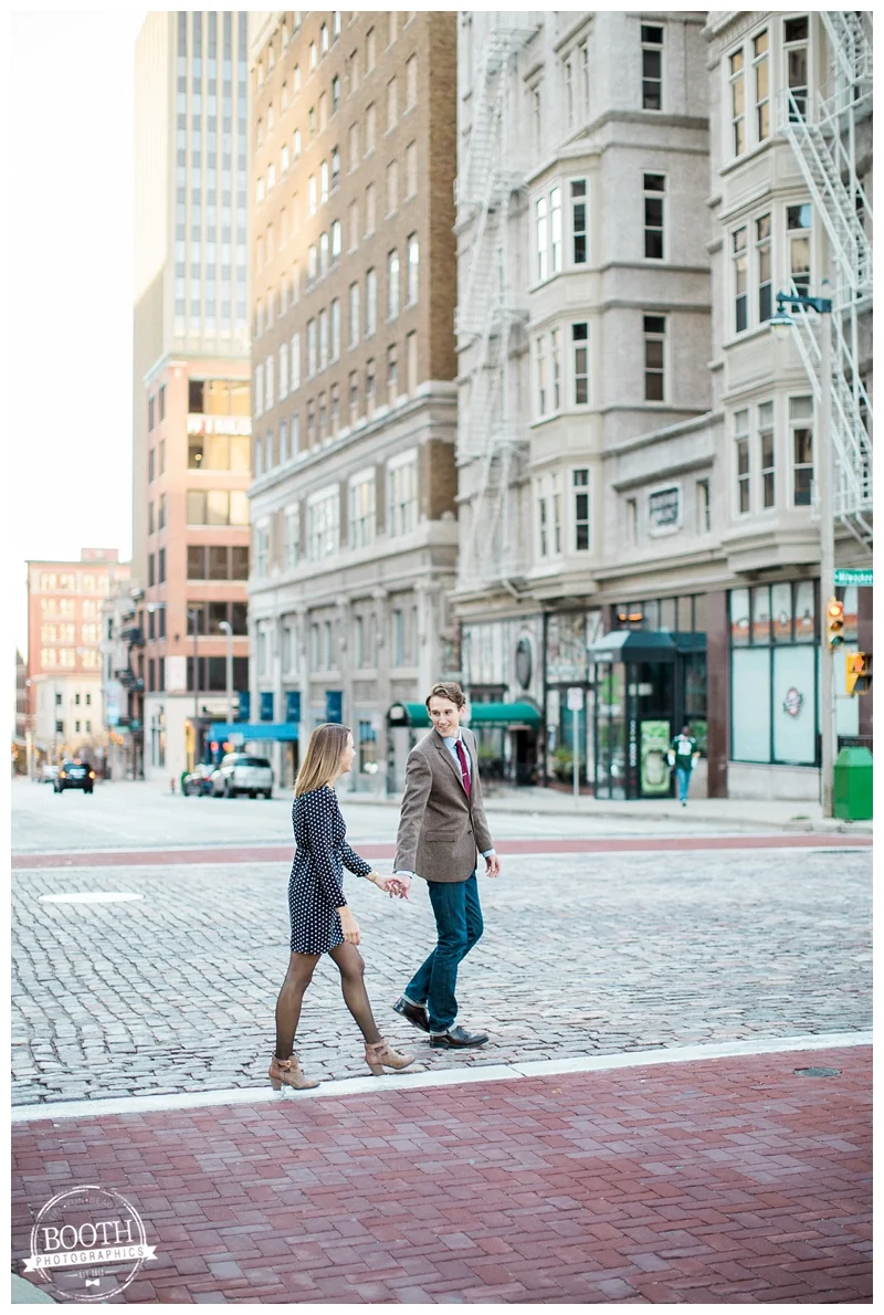 couple walking across brick streets in downtown Milwaukee Wisconsin