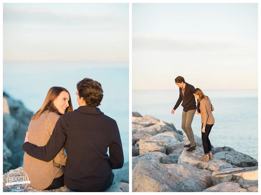 engaged couple walking along the rocks on Lake Michigan n Milwaukee Wisconsin