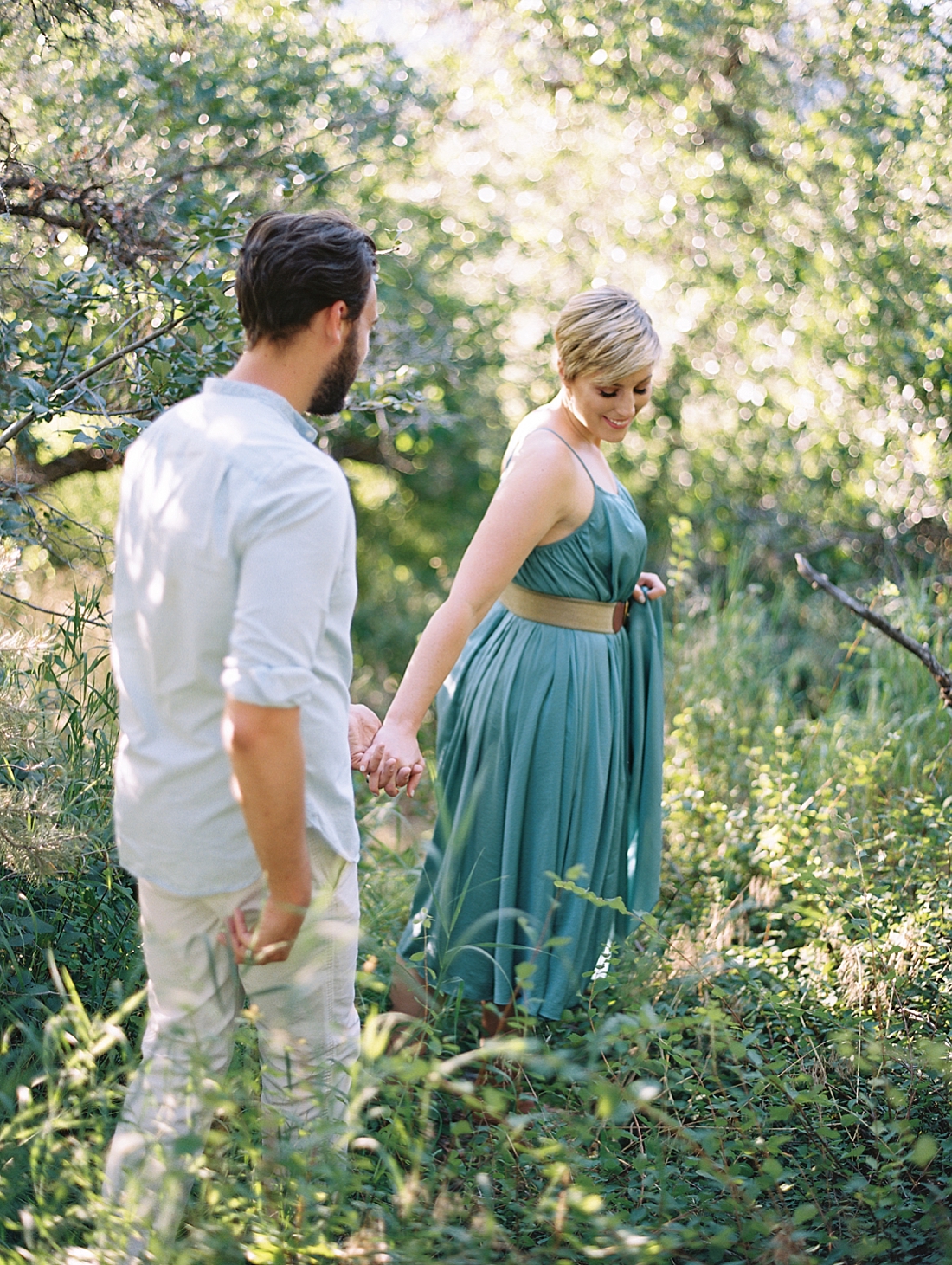 woman leading her husband through the woods.
