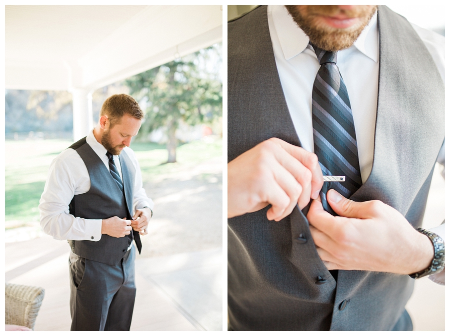 groom putting on his custom gray wool suit for his rustic fall outdoor wedding