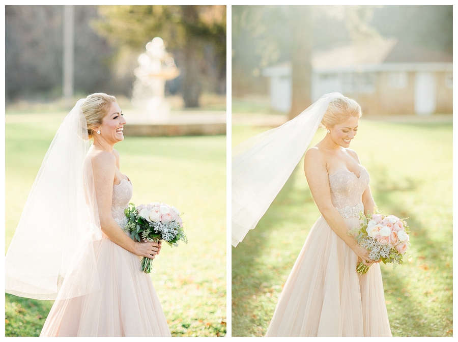 Bride carrying her blush and ivory rose and dusty miller bouquet at her rustic fall outdoor wedding