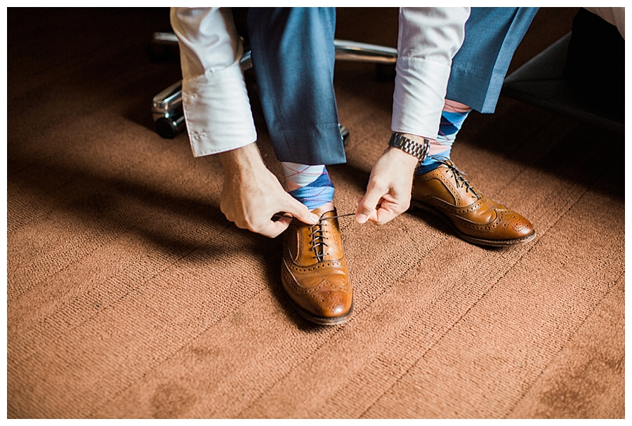 fine art photography of groom getting ready