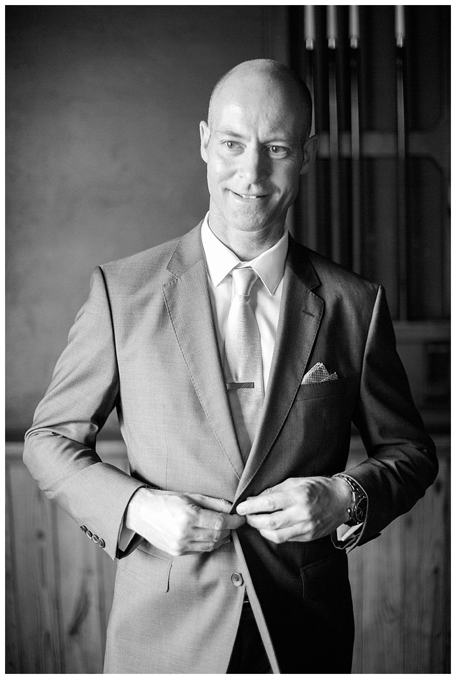 fine art photography of groom getting ready