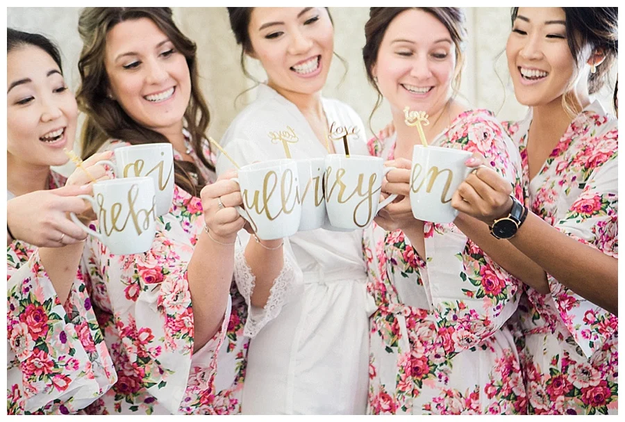 Bride and her bridesmaids toasting with custom coffee mugs