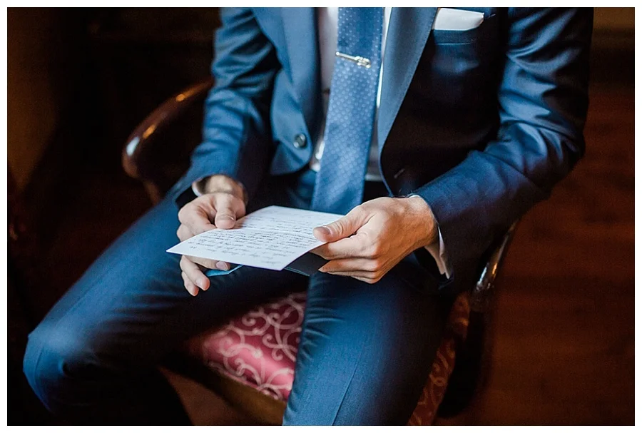groom reading a card from his bride for his Madison Club wedding